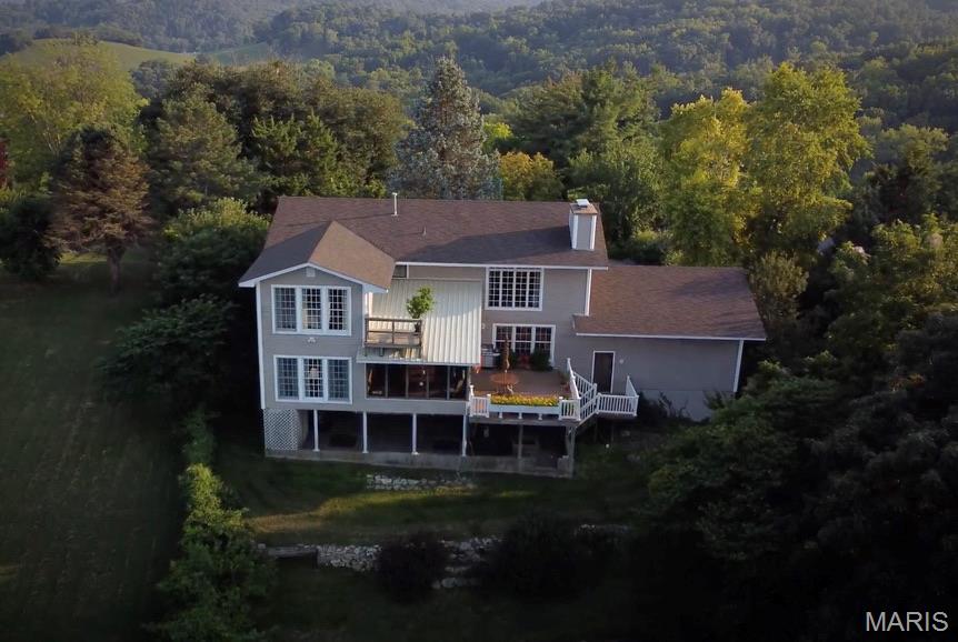 Beautiful home with a fantastic view of the Mighty Mississippi and Salt Rivers! Just as breathtaking are the plains of Illinois stretching far off into the horizon or the  majestic rock bluff jutting out to the east! So hard to drag one's self away from the the wooded valley, plains, & rolling river you may never get stuff done. Rain or shine, this home has something for you year round whether sitting outside or in because the views from every floor are just as great! Other features that make this home a winner! Charming stone walk-way and patio nestled in a lovely garden outside the front door.  Large primary suite is bright and airy & overlooks the river. Even has a high up tiny balcony of it's own. Just down the hall, another bed, bath and a spacious bedroom or bonus room that has many possibilities! Previously used for office and sitting room - but makes for great bedroom space. Either way with same amazing views. It's all gorgeous! Crown molding, hardwood floors, custom cabinetry w/granite counter tops, two fireplaces, French doors, and large expanses of windows name just a few of the features. Let's not forget bonus space in the lower level with sliding doors across the whole level that take you out to lower patio. Call to make this one yours!  
Preapproval or proof of funds to schedule showing. Suitable for Bed/Brk