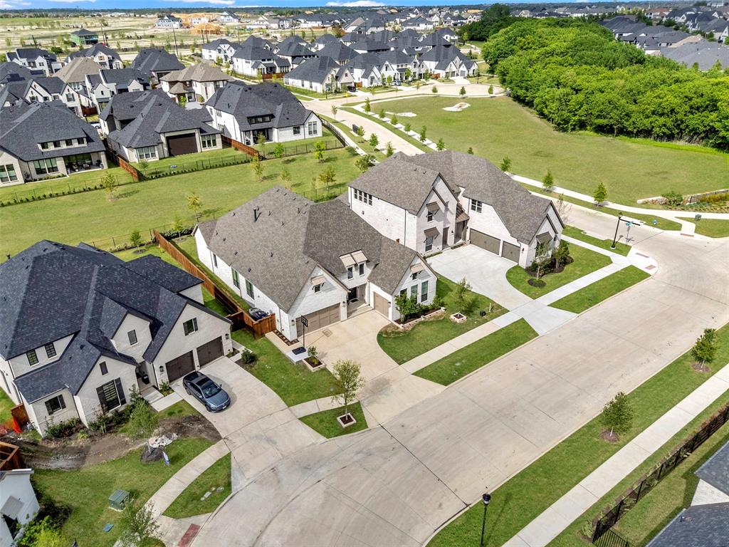 ONE STORY! Nestled in the highly sought-after community of The Grove in Frisco with NO PID or MUD, this exceptional American Legend built home offers the perfect blend of luxury, comfort, and thoughtful design. Just recently finished in 2024, this gorgeous home is ready for you to move-in without the wait of a long new construction timeline. Boasting 4 spacious bedrooms and 4.5 baths, every bedroom features its own private ensuite bath & walk-in closets —ideal for guests and multigenerational living. From the moment you step inside, you’ll notice the stunning light wood floors, designer color palette, and elevated finishes throughout. With over $40,000 in upgrades at build, no detail was overlooked. The open-concept living space is anchored by a beautiful fireplace and seamlessly connects to the outdoors through a wall of high-end sliding glass doors—creating the ultimate indoor-outdoor living experience. The chef’s kitchen is truly the heart of the home, showcasing gas cooking, a striking waterfall island, a large walk-in pantry, and an expansive dining area perfect for entertaining. Large game room makes for a great 2nd living space! The primary bedroom is a serene retreat with vaulted ceilings, dual vanities, a dedicated makeup desk, and a luxurious frameless glass walk-in shower. Additional half bath is perfect for guests. So much closet storage throughout this home! Laundry room with built-in cabinets and great counterspace. Mud room space with built-ins. Situated on a premium lot backing to a peaceful greenspace with privacy hedges already planted. 3 car garage. Residents of The Grove enjoy resort-style amenities including multiple pools, fitness center, parks, trails, dog parks, playgrounds, front yard maintenance & a vibrant community atmosphere with year-round events. Located in award-winning Frisco ISD, zoned for Liberty High School. This is elevated Frisco living at its finest—where style, function, and location come together beautifully.