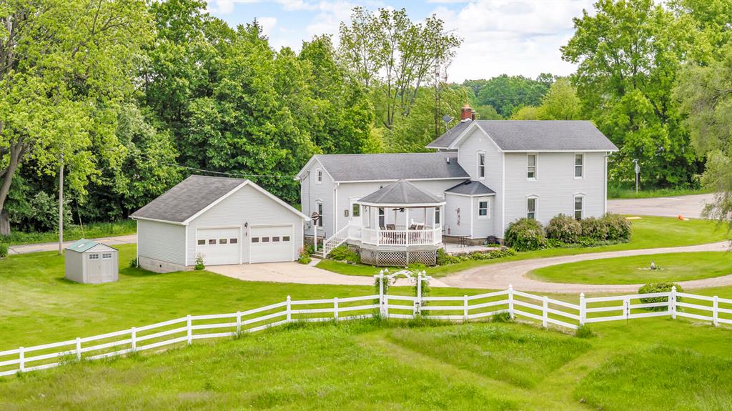 HOBBY FARM NW JACKSON COUNTY only 1.5 miles to I-94, Exit #133 - great for commuters. Peaceful setting surrounds this beautiful 4.5 acre farmette (possibly additional acreage available) - perfect for horses, chickens or other life stock, hobby farming, homesteading or simply enjoying wide-open spaces. Well maintained vinyl sided 1,900 sq. ft. home features 3 BR \ 2 BA, w/1 BR & bath on the main flr. Gorgeous custom BR furniture upstairs stays. Large nicely updated eat-in kitchen w/granite countertops. Formal dining rm, charming living rm w/wood burner, wood storage closet AND a parlor/library w/blt-in bookcases. 1st Flr laundry/mud rm (hidden door to basement). Relax in the vinyl/composite gazebo & enjoy views fields. 30x60 pole barn, ''run in'' barn, storage shed & 24x24 garage.  Enjoy the best of rural living without sacrificing comfort. FHA/VA/RD terms avail