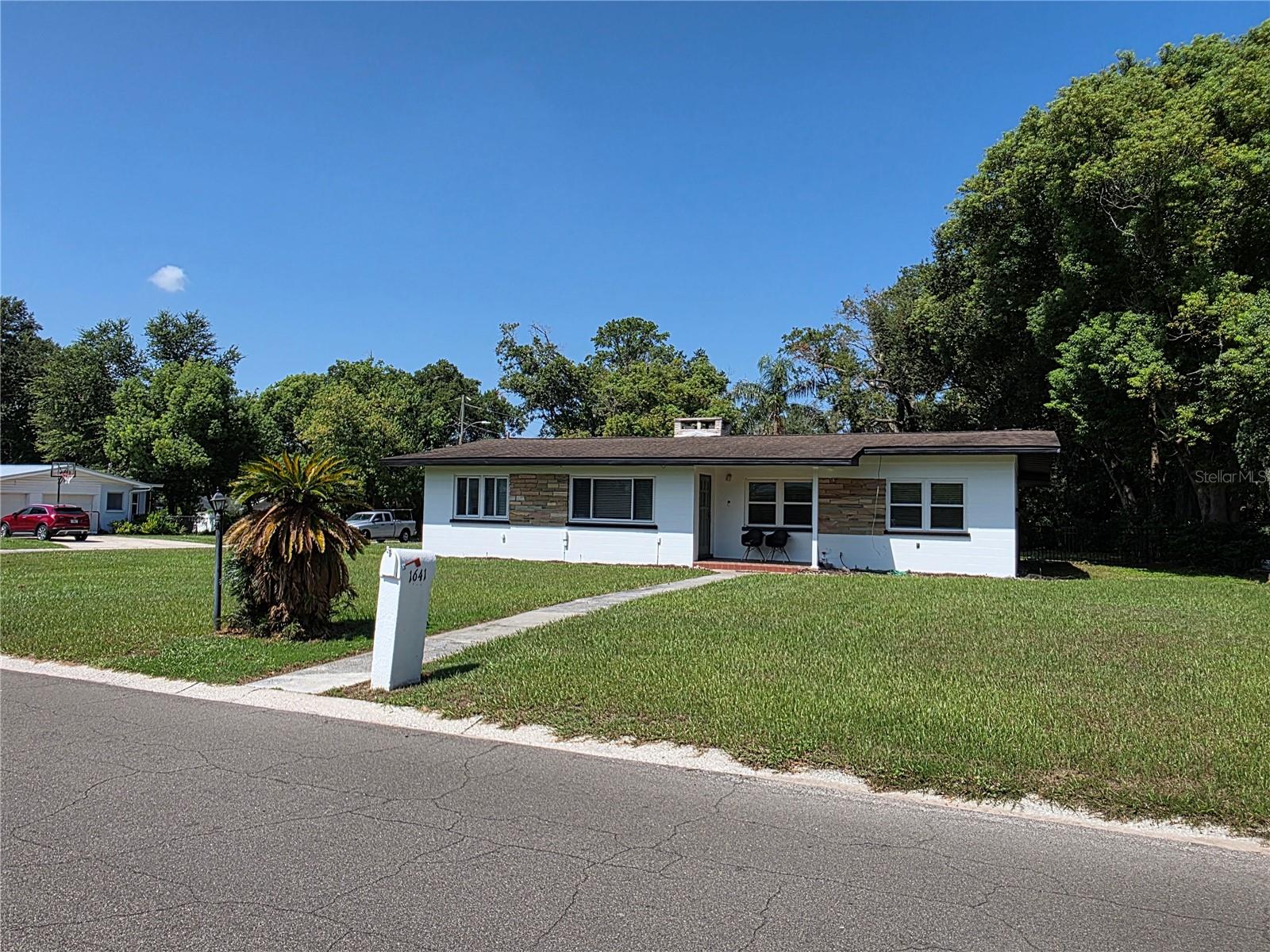 Spacious 4-bedroom 2 bath mid-century home is now available. Tile and laminate flooring in main living areas and carpeted bedrooms. Stainless appliances including dishwasher and over the stove microwave. The converted garage is a large 4th bedroom with a private entrance. Living room has a fireplace and is open to the dining room. There is a mudroom and indoor laundry. Great central Lakeland location near Lake Hollingsworth, Publix at Grove Park, and US 98. No HOA.