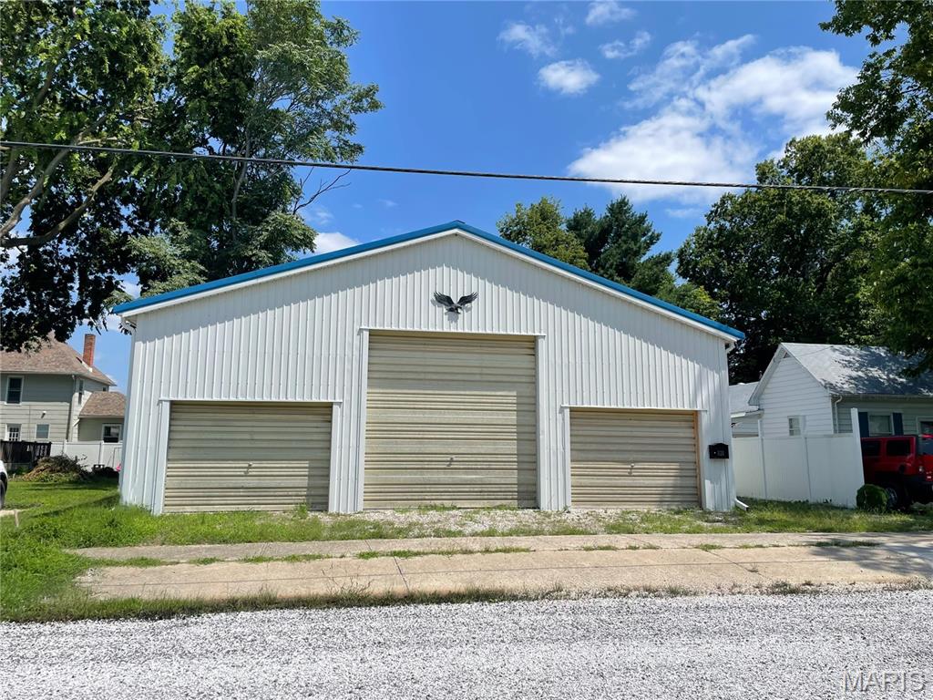 Ultimate Garage/Workshop Retreat with a modern interior living that space was remodeled in 2024. Epoxy flooring throughout gives a sleek look. Bedroom has ample space for an armoire. Kitchen comes with refrigerator, 2 plate cooktop, toaster oven & slimline microwave. Climate control includes all electric baseboard heaters, forced air wall heater in the living room, and two window AC units for year round comfort. A tankless electric water heater ensures endless hot water. Newer sewer lines to street, newer water lines & water meter. The garage (38’9”x26’ interior dimensions) is built for serious work & storage with 7’ and 12’ garage doors, floor drains, and plenty of room for projects, vehicles, and tools. A concrete patio at the entryway and a privacy fence add to the appeal. This is the ideal setup for a workshop enthusiast, tinkerer, or anyone looking for a rugged comfortable space to call home.  At just $61 per square foot for both living & garage space, this is an incredible value!