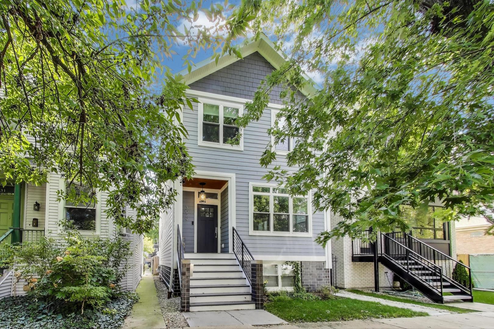 Discover the pinnacle of city living in this exquisitely renovated 4-bedroom, 3.5-bath home! Every inch of this residence showcases exceptional craftsmanship, seamlessly blending modern design with everyday functionality. The main level greets you with a bright and inviting front sitting room, a convenient powder room, spacious dining area, and a chef-inspired kitchen featuring quartz countertops, top-tier Thermador stainless steel appliances, a range hood, custom cabinetry, and an oversized Quartz island. The kitchen flows effortlessly into a cozy breakfast nook and a spacious living room-ideal for both casual living and entertaining guests.  On the second floor, you'll find three generously sized bedrooms and a well-placed second-floor laundry room featuring a utility sink, side by side top loader washer & dryer and built in cabinetry that adds both convenience and practicality. The Primary suite is pure luxury with soaring cathedral ceilings and an abundance of closet space complete with custom shelving in the walk-in closet plus two additional bedroom closets. The spa-like Primary bath boasts dual vanities, a large walk-in shower, and a separate soaking tub-your own private retreat. Both bathrooms feature exquisite custom tile work and dual vanities elevating the home's luxurious feel.  The lower level is light and bright, offering endless possibilities with an additional 4th bedroom, a full bath with a tub/shower combo, and a large recreation room complete with a wet bar-perfect for entertaining or unwinding. A second laundry room and ample storage complete this space.  The home's exterior pairs elegant brick and Hardie siding with a fenced backyard, lush landscaping, and a spacious deck overlooking the beautiful yard, perfect for outdoor relaxation. The 2-car garage includes a "party door" that opens directly to the yard-making outdoor entertaining a breeze.  Hardwood flooring on the main level, brand new carpet on the lower level and second floor. Dual zone high efficiency heat and ac.    Nestled on a peaceful, tree-lined block centered between Avondale and Logan Square, this home is within walking distance of the train station (Belmont Blue Line), steps to Milwaukee Ave, grocery stores, restaurants and shops, offering the perfect balance of tranquility and convenience.  With impeccable design and an unbeatable location, this home is truly a one-of-a-kind find!