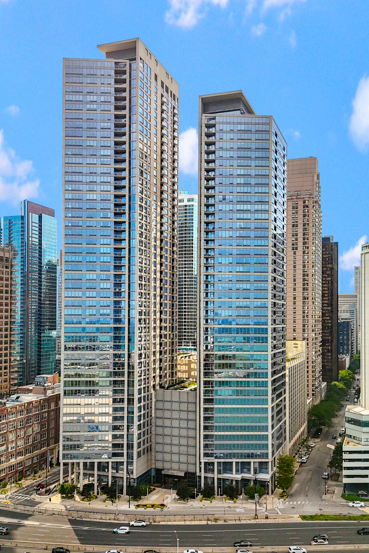 ONE OF THE BEST VIEWS IN CHICAGO - NE corner residence at 600 N. Lake Shore Drive offers sweeping, unobstructed views of Lake Michigan, Navy Pier, Ohio Street Beach, and the skyline. At over 2,500 sq. ft., this spacious 3 bed 3 1/2 bath home is move-in ready and perfectly positioned above it all, clearing surrounding buildings for postcard-perfect views from every room and your private balcony.   Significant updates include Lutron motorized shades, custom wall treatments, built-ins and closets throughout, newer washer/dryer, and electric fireplaces in both the living room and primary suite. The reimagined kitchen is designed for both everyday living and entertaining, with abundant cabinetry, granite countertops, and high-end appliances-Bosch refrigerator and microwave, Fisher Paykel dishwasher, and GE Profile double ovens and cooktop. A wet bar elevates the space with quartz countertops, custom shelving with integrated lighting, a glass backsplash, and a beverage refrigerator.    A rare opportunity to secure one of the city's premier views at an unmatched value.   2 parking spots available at $50k each.    600 Lake Shore Drive is a premier building featuring an elegant lobby and full-service 24-hour door staff. Residents enjoy multiple terraces with panoramic city and lake views, outdoor grills, firepits, and lounge areas, plus community rooms with full kitchens, and a golf simulator coming soon.   All of this is steps from Ohio Street Beach, the lakefront path, Northwestern hospital, world-class dining, and the Magnificent Mile!