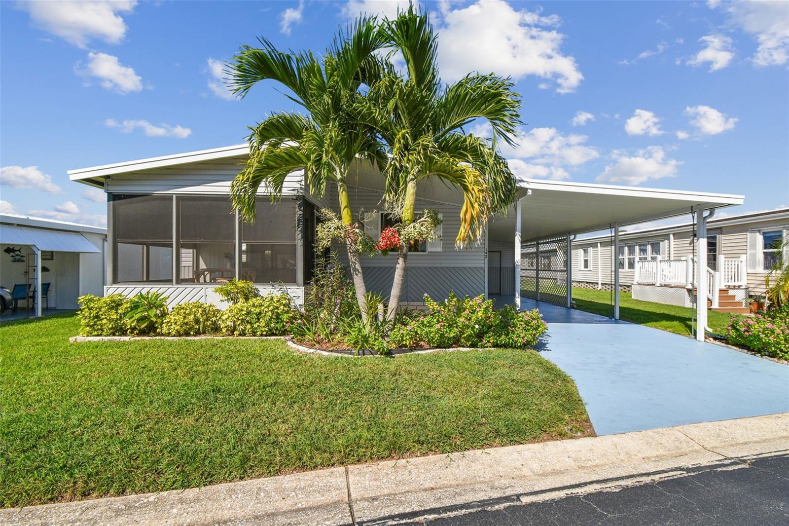 Welcome to Glenwood Estates, one of the area’s most vibrant 55+ communities—where you own the deeded land (this is not a co-op community)! This well-maintained manufactured home is move-in ready and packed with features that make Florida living easy and enjoyable.

Step inside to find vaulted ceilings and laminate flooring throughout the main living areas, giving the home an open, airy feel. The spacious storage/laundry room offers plenty of room for hobbies or organization, while carpeted bedrooms keep things cozy. You’ll also appreciate the newer HVAC, hurricane tie-down straps, and freshly painted driveway that add comfort and peace of mind.

Outside, you’ll love the covered carport, colorful landscaping, and great curb appeal that make this home stand out.

The community itself is beautifully maintained and full of activity—featuring a clubhouse, heated pool, shuffleboard courts, and even a lake with a fishing dock. Residents enjoy an active social calendar, golf cart–friendly streets, and the convenience of being close to beaches, shopping, dining, and airports.

Whether you’re looking for a year-round residence or a seasonal getaway, Glenwood Estates offers the perfect blend of comfort, community, and location.