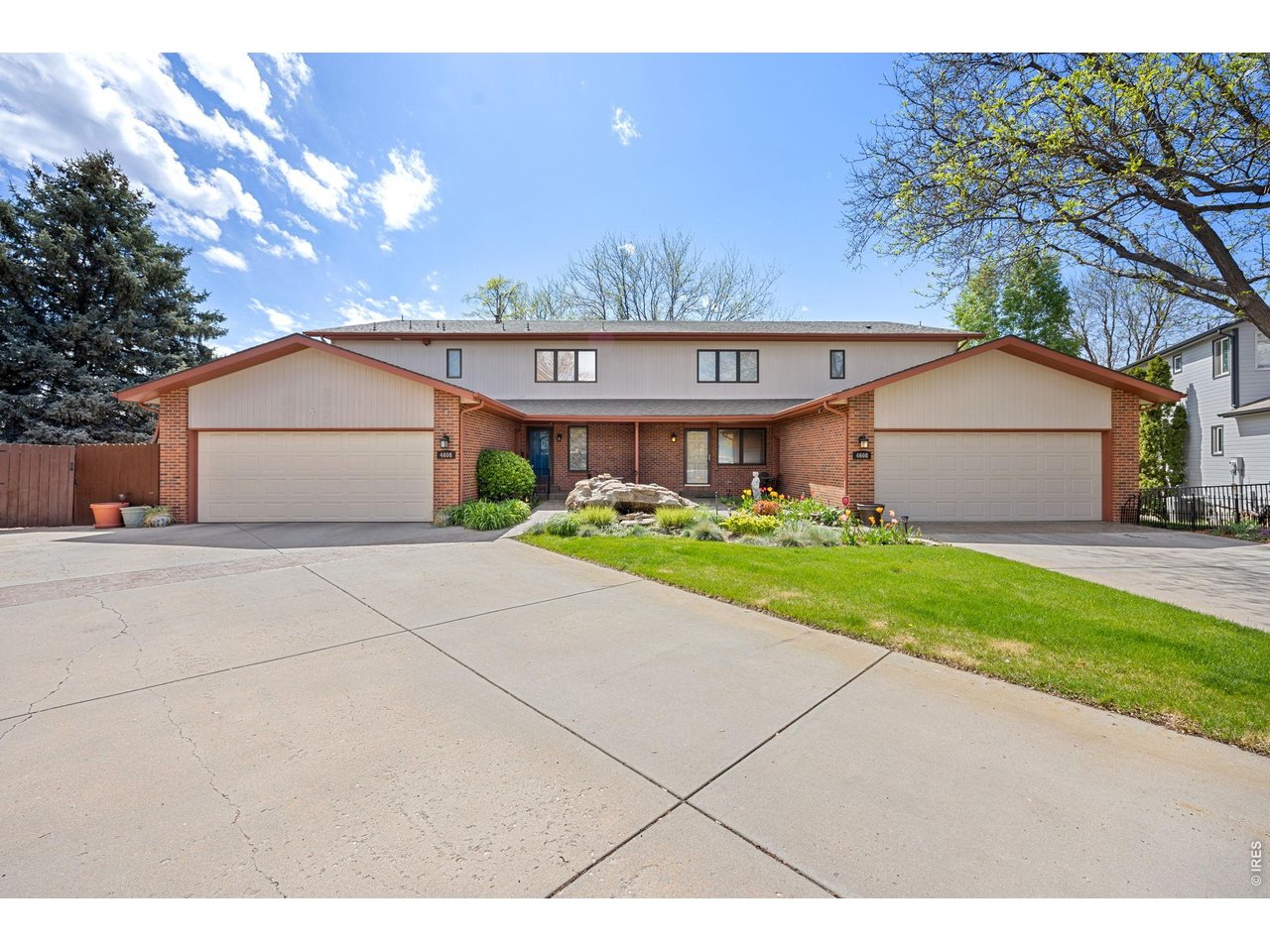 Spacious 4-Bedroom 1/2 Duplex with Dual Primary Suites Near Country Club & Parks! Welcome to this beautifully designed 1/2 duplex offering 4 spacious bedrooms, 4 bathrooms, and 3,420 square feet of versatile living space. Perfect for multi-generational living or hosting guests, this home features two luxurious primary suites with their own private baths and generous closet space. The lower-level primary suite, located in the garden-level basement, includes a cozy wood-burning fireplace, creating a warm and inviting retreat. The open floor plan creates an ideal atmosphere for both entertaining and everyday living. A two-sided gas fireplace between the living room and dining room adds ambiance and style, while the kitchen impresses with granite countertops and ample cabinetry. Large windows throughout the home bring in natural light, and two brand-new Trex decks provide low-maintenance outdoor spaces for relaxing or entertaining. An oversized 2-car garage adds convenience and storage. Located just minutes from the country club, Aims Community College, and several scenic parks, this home blends comfort, quality, and a prime location. Don't miss your chance to own this rare gem- schedule your showing today!
