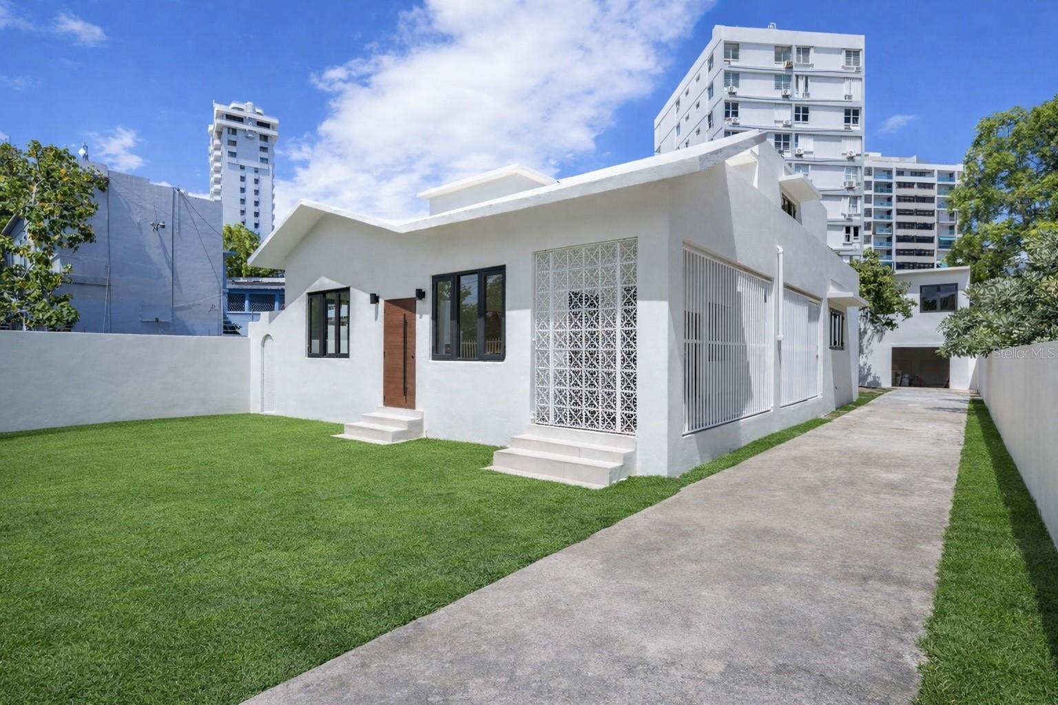 One or more photo(s) has been virtually staged. Looking for a versatile property in Condado with strong income potential? This fully renovated multi-unit property offers an excellent opportunity for short-term rentals (Airbnb) and/or the potential for commercial use.Situated on a 596-square-meter lot with approximately 3,058 square feet of gross living area, the property features a total of 7 bedrooms and 5 bathrooms across four (4) separate units, divided between a main house and a rear structure—each with two levels.Main House:    •    First Level: 3 bedrooms, 2 bathrooms    •    Second Level: 2 bedrooms, 1 bathroomRear Structure:    •    First Level: 1 bedroom, 1 bathroom    •    Second Level: Studio with 1 bathroom    •    The property has just undergone a complete renovation, including new flooring, windows, updated electrical and plumbing systems, and new A/C units.The spacious lot offers excellent outdoor potential, with room to create a custom patio, pool, lounge area, or garden. The main house also features a covered porch on the first level and a large terrace on the second level, seamlessly blending indoor and outdoor living.Ideally located in the heart of Condado, the property offers excellent visibility and accessibility, with close proximity to major tourism hubs, the beach, supermarkets, restaurants, hotels, and more.Additional features include a covered carport for one vehicle and extra parking space in the driveway. This property is sure to move very quickly.