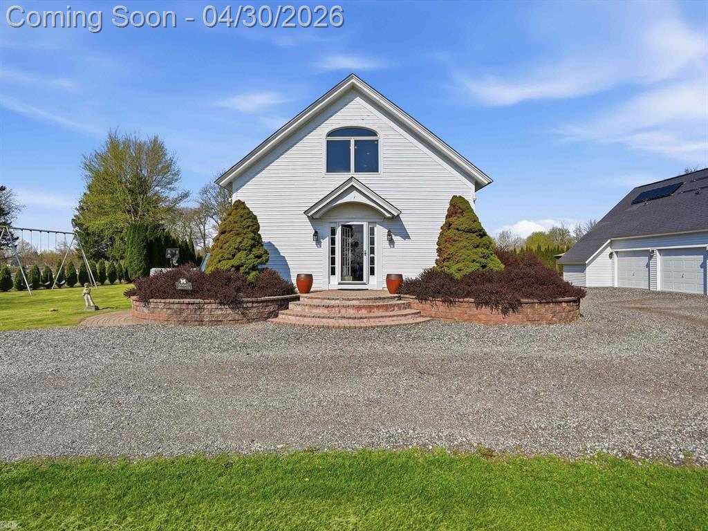 **OPEN HOUSE 5/2 AND 5/3 FROM FROM 12PM-3PM.** Step into a truly one-of-a-kind home where historic charm meets modern features. Originally built in 1860 as the Davis Schoolhouse, this beautifully renovated residence has been thoughtfully transformed into a stunning, open-concept living space while preserving its unique character.  This 3 bedroom, 3.5 bath home features a two-story great room with loft-style architecture, creating an open and airy feel throughout. The updated kitchen is equipped with granite countertops and stainless steel appliances, seamlessly flowing into the inviting family room with a cozy fireplace perfect for both everyday living and entertaining.  The interior boasts hardwood floors, a first floor laundry room, and a dedicated home office or den. The primary suite has been recently updated with an updated bathroom, adding a fresh touch to the home's timeless design.  Situated on a spacious 1 acre lot with no HOA and within Romeo Schools, the property offers incredible outdoor living. Enjoy a large deck, outdoor kitchen, fire pit, gazebo, in-ground speakers, and even an outdoor movie screen-creating a true backyard retreat.  Additional highlights include a 3.5-car garage with approximately 1,000 sq. ft. of heated loft space, providing endless possibilities for storage, a workshop, or additional living space.