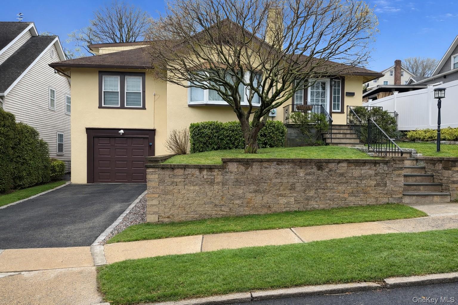 Located in the historic Battle Hill neighborhood, this Cape Cod-style home offers the perfect blend of comfort, and convenience. Featuring 4 bedrooms and 2.5 bathrooms, the home boasts a spacious living room with a fireplace that flows into a formal dining room—ideal for everyday living and entertaining. Hardwood floors throughout the first and second levels add warmth and character.The eat-in kitchen is equipped with stainless steel appliances, while the sunroom provides a bright, inviting space with direct access to a covered patio—perfect for relaxing or hosting guests. A welcoming front porch adds to the home’s curb appeal.A partially finished basement offers flexible space for a home office, recreation room, or gym. Additional highlights include a 200-amp electrical service, gas boiler, newer windows, an extra-wide driveway, and front wall were all updated in 2013. Enjoy a lovely, level backyard and a prime location close to Metro-North, shopping, restaurants, downtown White Plains, and major highways and parkways.