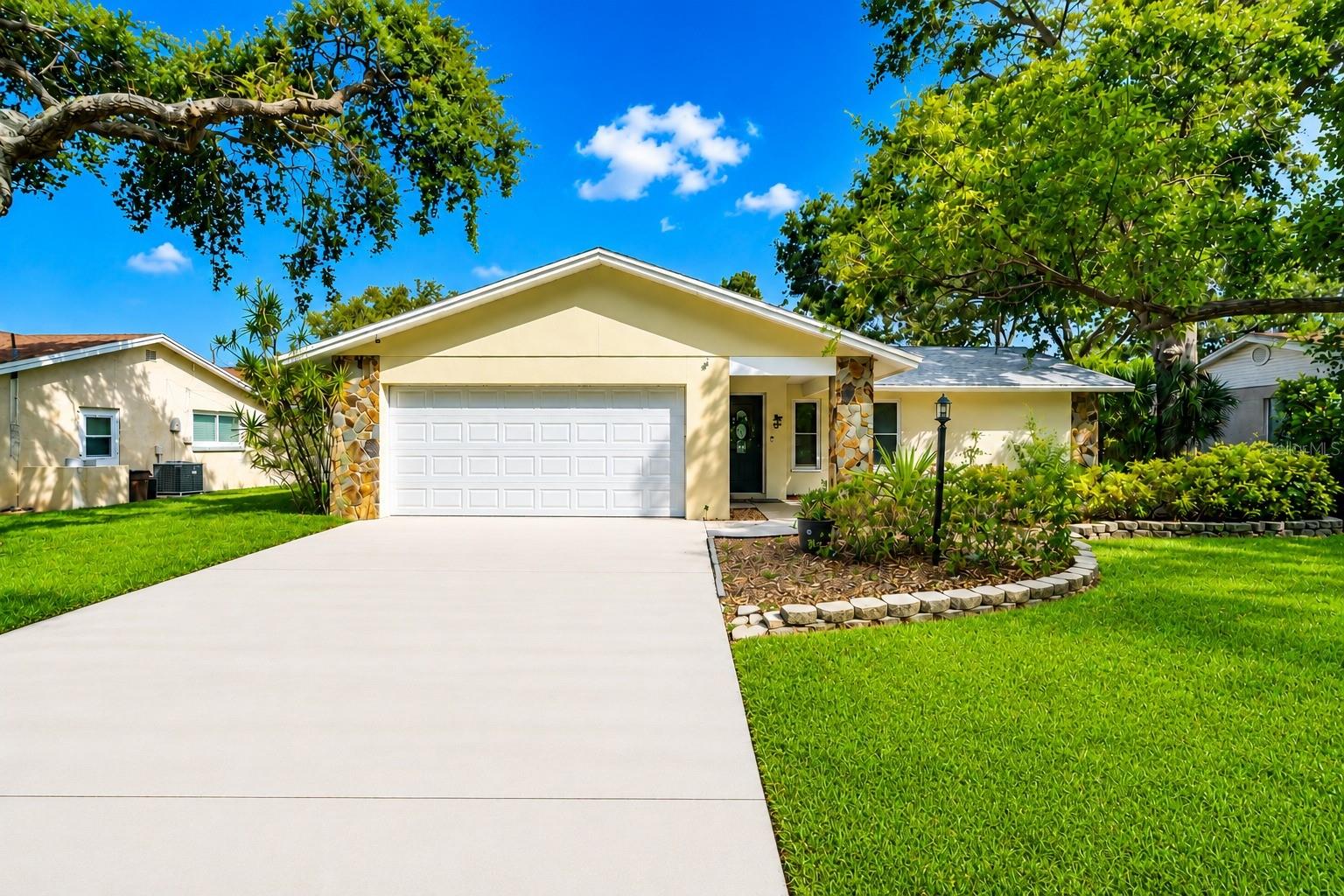 Welcome to this stunning 4-bedroom, 3-bathroom pool home nestled in the desirable Yacht Club Estates neighborhood of Largo, FL! This beautifully updated single-family residence offers 2,244 heated square feet of open-concept living, just 2 miles from the pristine shores of Indian Rocks Beach.Step inside to discover a bright and airy layout featuring luxury vinyl and carpet flooring throughout, soaring ceilings with ceiling fans, and an abundance of natural light. The chef-inspired kitchen is a true showstopper, boasting solid wood cabinets with sleek black hardware, stunning stone countertops, a large center island with sink, stainless steel appliances, and stylish pendant lighting — all open to the family room and dining area, perfect for entertaining.The spacious primary bedroom is conveniently located on the main floor and features a walk-in closet. Three additional bedrooms provide plenty of space for family and guests, each with built-in closets.Outside, enjoy your own private resort-style oasis! The backyard has been completely transformed with brand new decking (2025), a new pool slide (2025), a new WiFi-enabled pool heater (2024), and a new pool pump (2024) — all surrounding a sparkling in-ground pool with auto cleaner and child safety fence.This home is loaded with major recent upgrades, including 2 new AC units (2025) and a full remodel completed in 2024, ensuring years of worry-free living. Additional highlights include a 2-car attached garage, irrigation system, wood-burning fireplace, and an oversized lot of over 10,500 square feet.Located in a beautiful, quiet neighborhood with wonderful surroundings, this home is truly spacious, spotless, and move-in ready — as guests have described it, "a really beautiful home in a very nice neighborhood." Every detail has been thoughtfully maintained, from the pristine kitchen and squeaky-clean bathrooms to the clutter-free living spaces and immaculate furnishings.This exceptional, fully upgraded home is a rare find — schedule your showing today!