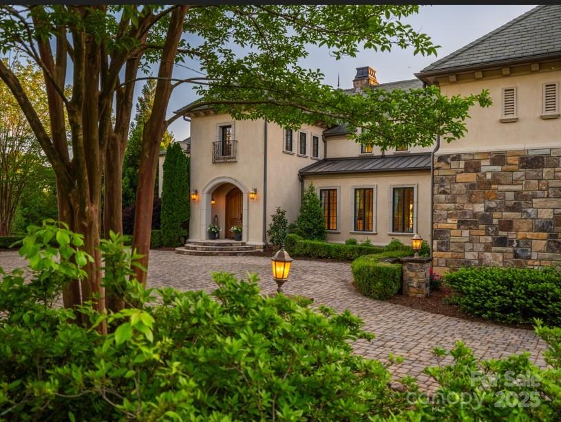 Thanksgiving Hill blends seclusion and convenience—just minutes from TIEC, Landrum, and within easy reach of Asheville, Greenville, Spartanburg, and airports including GSP, AVL, and CLT. This 38+ acre equestrian estate offers a five-stall barn (expandable), climate-controlled tack room with laundry and bath, wash bay, feed room, 150' x 75' covered arena with sprinklers, fenced paddocks, jump course, and direct trail access along the North Pacolet River. A separate two-bedroom guest house is perfect for a trainer or guests. The 6BR/6.5BA main residence features a gourmet kitchen with dual islands, butler’s and walk-in pantries, keeping room with fireplace, dual offices, bar, gym, sauna, steam room, theater, and game room. The great room and primary suite enjoy breathtaking views of Hogback Mountain and pastures. Outdoor amenities include a veranda, kitchen, hot tub, saltwater heated pool, terrace, gazebo, and putting green—all with stunning mountain views.


.