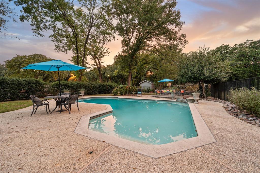 Don’t miss this RARE opportunity to own a beautiful 5 bedroom custom home with a 3 car garage on nearly an acre in the heart of Irving! Set behind a private gated entrance, this magnificent property is surrounded by lush, mature trees & the backyard feels like you are in your own private park! As you step inside you are greeted by vaulted ceilings, a winding staircase and a warm, inviting atmosphere. The dedicated executive style office features floor-to-ceiling built-ins and a cozy fireplace, perfect for work or relaxation. The formal dining room opens into one of multiple spacious living areas, while the eat-in kitchen is a chef’s dream with a built-in refrigerator, double islands, dual sinks, abundant custom cabinetry and the breakfast nook is flooded with natural light. The primary suite, conveniently located downstairs, offers a true retreat complete with a built-in desk, sitting area, sauna, cedar closet, dual sinks, soaking tub, and a spacious walk-in shower! Upstairs boasts three additional bedrooms, two full bathrooms, and a game room with several closets and built-in shelving for all your storage needs, makes the ideal spot for movie nights or a playroom. Step outside to your own private oasis with plenty of room to roam, featuring a covered patio, a sparkling diving pool, a storage shed and opulent, mature trees that provide shade and serenity. This expansive property offers endless possibilities for outdoor enjoyment, right in the heart of the city!