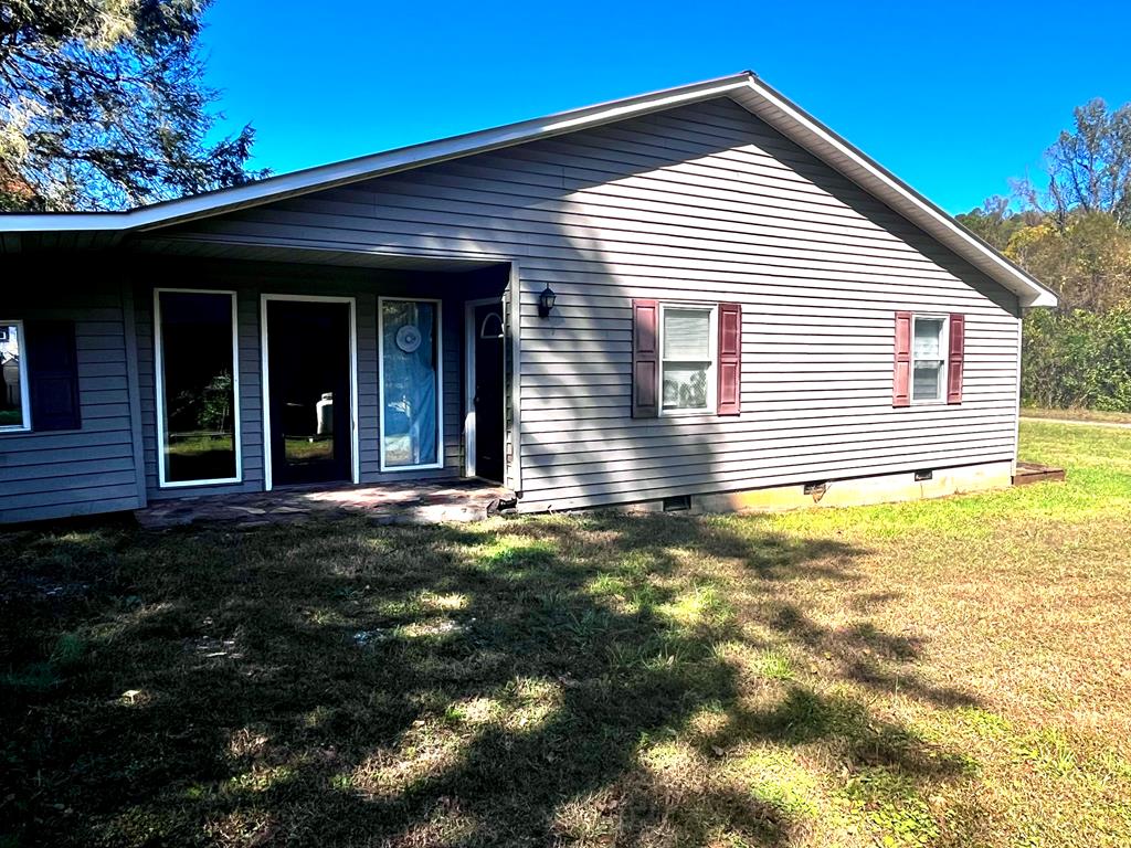 PRICED BELOW TAX ASSESSMENT of $51700. Flippers, Investors, or ambitious people looking to create themselves an economical home, YOU NEED TO HAVE A LOOK! This bungalow sits on a tad under an acre of land with approximately 130ft of Poorhouse Creek frontage, a well known trout stream. The new section of the home has a metal roof, replacement vinyl windows, vinyl siding, and a vented block foundation. The home boasts truss rafters, making it possible to create a large open concept living space. The newest section has Sheetrock walls, and plywood flooring, and a complete bathroom. The home has electricity, and what appears to be a newer 200 amp panel box, but the current owner has no knowledge of any previous wiring. The home is in a 100yr flood plain, and per FEMA regulations, no new additions can be built to the home, so the preexisting 1950 portion of the structure has been left as “grandfathered” square footage for possible remodeling and additional square footage, but currently is a shell with some wiring and plumbing, but the condition is of either is also unknown. The home is being sold as is-where is, and is a blank canvas for a innovative buyer. The neighborhood consist of 4 other full time households. They share ownership of the road and the newly built bridge leading into the community.The buyer of this property must help maintain their portion of the entry road.This property is in the foothills of the Blue Ridge Mountains, just outside of the town of Stuart making it not only convenient to the trout stream out front, but it's also close to town where there are restaurants, shops, grocery stores, and a new hospital opening soon.The home is also only  30 mins from Mt. Airy NC, only minutes to the Blue Ridge Parkway, and 25 mins to Fairystone State Park. Usage ideas include an Airbnb, a residential rental for medical professionals a long term rental or a fulltime residence.