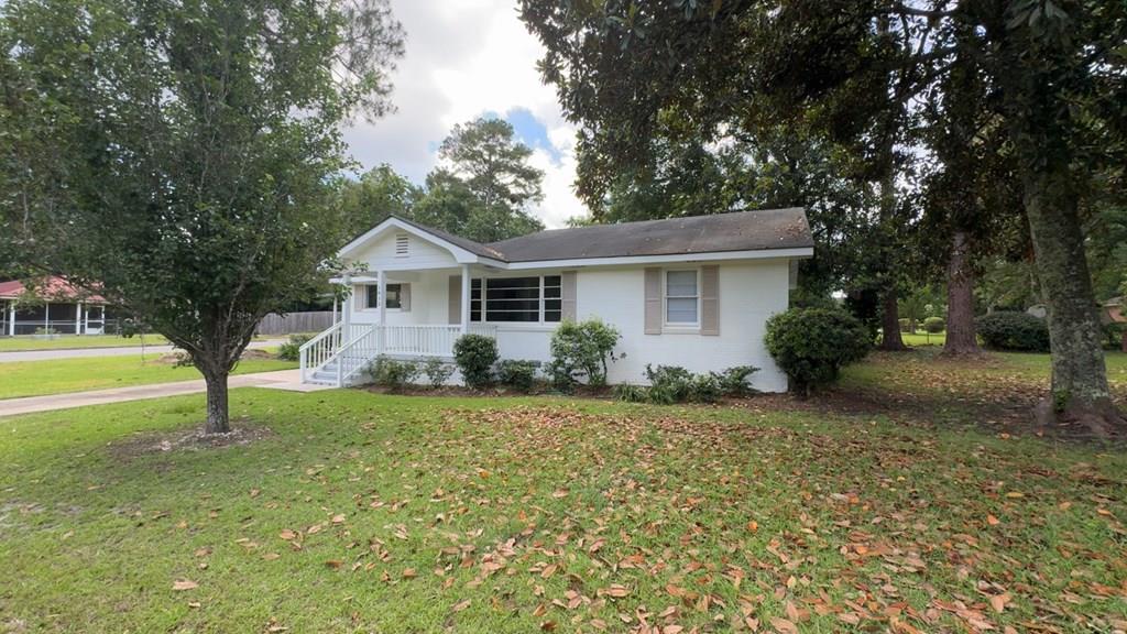 Charming, newly updated 3 bedroom home in a prime location close to everything! Home is conveniently located in town, offering easy access to shopping, dining, and all the amenities you need. With just over 1,300 square feet of living space, this property is ideal for first-time homebuyers or those looking to downsize. Inside, you'll find beautiful hardwood floors throughout the living areas and bedrooms, complemented by durable tile in the kitchen and bathroom. Freshly painted both inside and out. New tile shower and floors in bathroom and vanity. New countertops and appliances in kitchen. The functional layout makes the most of every square foot, ensuring a comfortable and inviting space to call home. The property also features a single attached carport for convenient parking and a separate storage building for all your extra belongings. Stackable washer and dryer are included.