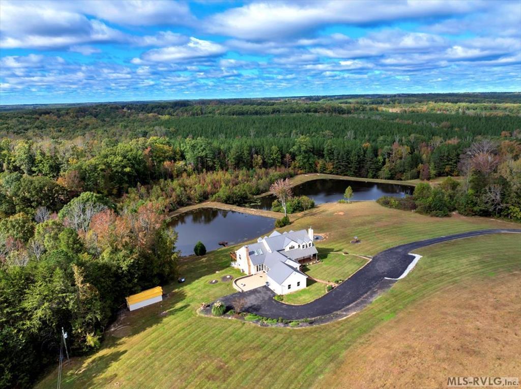 Serenity and peace is what this 65.25 acre piece of land with two homes and two ponds on it represents. Starting down the long winding paved driveway with stone column entrance you end up at 539 Stoney Cross Road. Here overlooking two ponds you find a newly renovated and expanded home with well over 4,200 sq ft of living space, a double attached garage, 4 bedrooms with 1 flex room, 2.5 baths, and a now fully finished basement. Some improvements since the seller's purchase-new metal roof, fully finished the basement but leaving plenty of room for storage, built outdoor patio off the basement level, added landscaping and fire pit, new 5 ton Bosch HVAC unit, new lighting, and the list goes on and on. This home has beautiful hardwood floors and the primary bedroom and bath is on the main level. The chef's kitchen is very large having solid surface countertops, double ovens, drop in electric range, and built in Sub-Zero refrigerator. The main level also features a flex room, 2 living areas, a gorgeous dining room, half bath, laundry, and expansive decking overlooking the ponds. As you wind up the floating staircase there are 3 bedrooms, a full bath, and nice area for separate living space or office. In the basement there is luxury vinyl plank flooring and wide open space to do whatever you can imagine or would want to do. There is a unique old barn with a lean to on the property and some paths cut for riding an ATV. Up on the road is a guest home with 2 bedrooms and 1 full bath, eat in kitchen, and great room. Come live in the country while only being 25 minutes away from South Hill, 15 minutes from Chase City, 20 minutes to Clarksville/Buggs Island Lake, or 30 minutes to Lake Gaston. What more could you possibly ask for!