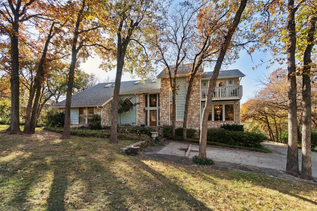 Discover timeless mid-century design in this beautiful home, perfectly set on an oversized, almost 1/2 acre wooded lot in sought-after SE Edmond. Surrounded by mature trees and exceptional curb appeal, this property offers a rare blend of character, privacy, and convenience—just minutes from highways, shopping, restaurants, and top-rated schools. Inside, the flexible layout features four bedrooms with the primary bedroom suite and one guest bedroom with private bath on the main level, 3 1/2 baths total, two spacious living areas, and two dining spaces, ideal for both everyday living and effortless entertaining. A bonus space provides the perfect spot for a dedicated study, exercise room, hobby space or a 5th bedroom. Upstairs, both secondary bedrooms open to private balconies, creating a true retreat with peaceful wooded views. Multiple patio areas in the back yard offer endless opportunities for outdoor dining, lounging, or gathering under the trees. Additional parking expands your options for guests, trailers, or extra vehicles, while the mid-century architectural details throughout bring warmth and personality to every space. A rare opportunity to own a stylish, well-located home on an exceptional lot in one of Edmond’s most convenient corridors—this one simply stands out.