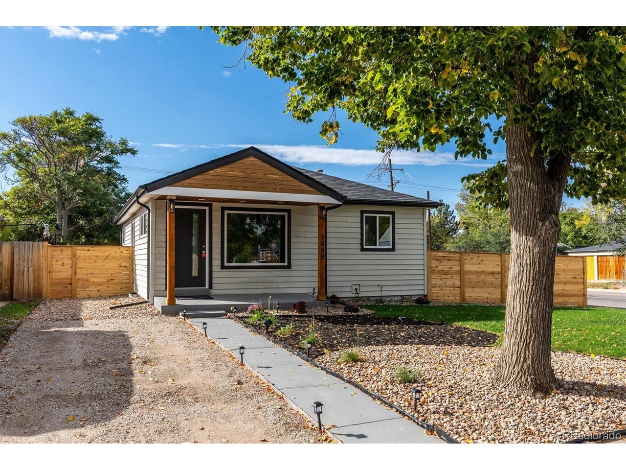 Completely remodeled and ready to impress! This inviting corner-lot home blends modern finishes with comfortable living, offering 5 bedrooms, 2 beautifully updated bathrooms, and 1,872 total square feet. Step inside to an open-concept main living area featuring new laminate flooring and fresh interior paint. The thoughtfully redesigned kitchen anchors the space with new cabinetry, new stainless steel appliances, and a large island that brings everyone together. From morning coffee to weekend gatherings, this welcoming layout makes everyday living and entertaining feel effortless. Three main-level bedrooms offer flexibility for sleeping, working, or hosting. The fully remodeled main-level bathroom features a new vanity, updated tile, glass shower doors, and accent lighting in the shower niche and surrounding shower area for a sophisticated finishing touch. Downstairs, the finished basement expands your living space with a large family room ready for movie nights, game days, or a comfortable retreat. Two additional bedrooms provide room to spread out, while a fully modernized three-quarter bathroom carries the stylish design throughout the home. A finished laundry and mechanical room adds everyday convenience. The finished basement also features a convenient sink and cabinetry, offering additional storage and a versatile space for refreshments, hobbies, or everyday needs. Outside, enjoy fresh front landscaping, new fencing, and a corner-lot setting with space to make your own. A front driveway and generous off-street parking in the rear offer valuable flexibility for multiple vehicles. A new roof adds another significant improvement to this extensive remodel. With inviting gathering spaces on both levels, a standout kitchen, refreshed bathrooms, and substantial updates inside and out, this home delivers the space and style you have been searching for. Come experience the transformation and picture your next chapter at 1689 Lansing Street!