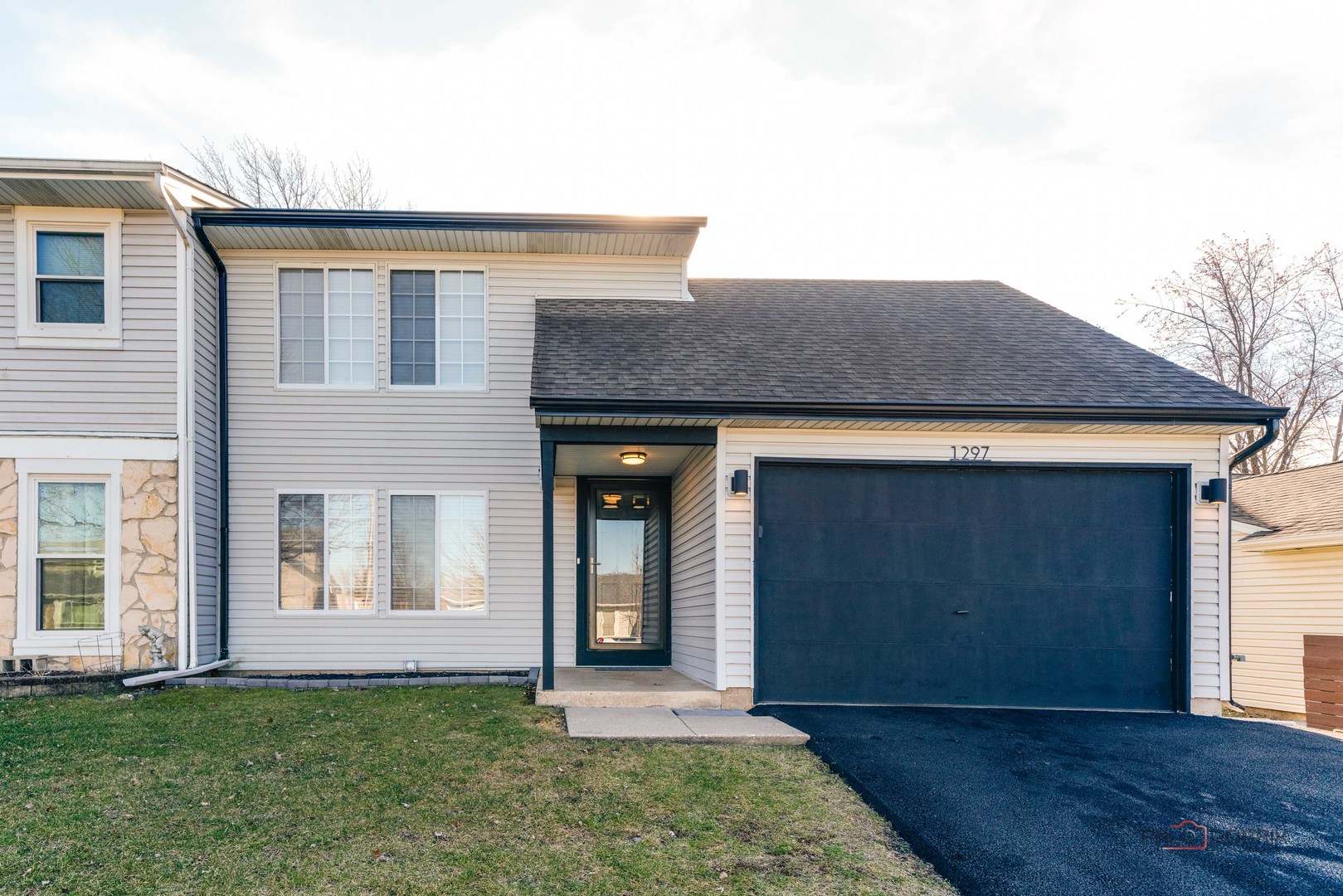 Stop Renting!  Come take  a look at our affordable 2 story duplex cleaned and ready for you! 2 spacious bedrooms, 1.1 baths, living room, family room (which might make an ideal first floor 3rd bedroom) and deep attached garage.  Relax and enjoy your own fenced back yard! The back yard now features a newer private 6' wood fence and storage shed. Other updates: Newer A/C, Furnace, Humidifier, Thermostat, and Water heater too.     Newer 100 amp electrical panel in garage. Newer furnace for garage (ideal for workshop or Man-Cave!). Don't miss the built-in "Work Bench" (folding table) - stays with home.    Asphalt Driveway recently replaced (park 2 cars side by side). Wide one car garage.    Enjoy the Kitchen with updated stainless steel appliances and new large single sink (owner to leave the kitchen island). If you love entertaining, you'll love the open living and dining room area.     The 2nd floor features two large bedrooms anmd generous closet space and laundry closet with newer updated Washer and Dryer.  There will be a detailed feature sheet for more information.    Master bedroom closet does not have closet doors; no doors will be added.  Sliding glass door is sold in as-is condition but still works.    NO monthly association fees!  Why rent when you can own your own place?!?!