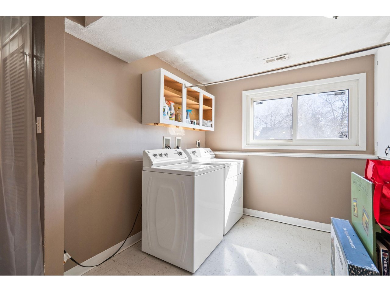 Possibilities abound on this large corner lot with alley access allowing for RV, boat, or trailer parking-plus no HOA, covenants, or metro district. This home features a fully owned, free-and-clear solar system, helping keep energy costs low year-round. The sunny upper level offers a comfortable living room, a bright kitchen with abundant counter space and a gas range, and two bedrooms with a full bath. The dining area walks out to a Trex deck overlooking the expansive backyard, creating a great space for outdoor dining and entertaining. (The sliding patio door will be replaced prior to closing). The lower level provides excellent flexibility with a large third bedroom that could easily serve as a family room or private primary suite. A fourth bedroom works perfectly as a home office, guest room, or hobby space. You'll also appreciate the spacious laundry area with additional storage and the oversized one-car garage. Outside, the generous yard includes garden beds, a storage shed, and plenty of room to expand, play, or park your toys. A brand new roof and gutters will be installed prior to closing. Average utilities from May 2025-Oct 2025: Water-$155/month and Electric-$15/month.
