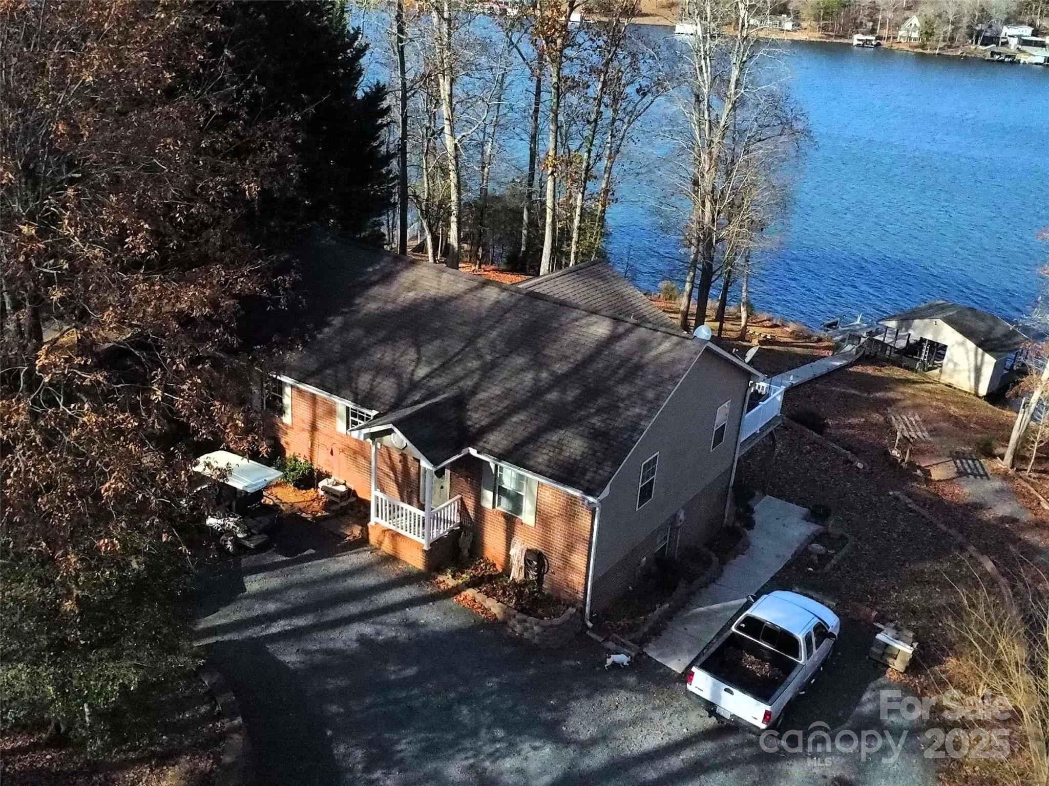 LAKE TILLERY TIME If you are thinking about lake Tillery, come on down.  Three bedrooms and two baths' upstairsand a separate living area in the basement with two more bedrooms and a bath, full kitchen and living area.  Wonderful screened porch and deck on the main, and a porch out the basement doors that is covered and has a wonderful view of the lake.  This home also has a double boathouse, with a concrete walkway down to the Duke line. It also has a concrete walkway going to the basement apartment, so it has easy access for everyone.   Morning coffee on the screened porch would be Heaven with the magnificent water views of Tillery. This home would make a great vacation rental with the five bedrooms, and it is priced to sell.  Give me a call.Professional photos and measurement on 12/01