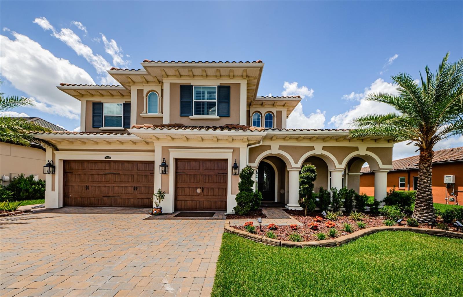 **Price has been improved! Sellers are also offering a comprehensive 1 YEAR Warranty on systems (AC, Plumbing, Electrical, Appliances, etc including Saltwater Pool and Spa equipment).**Step into luxury in owning this breathtaking 4-bedroom, 4-bathroom estate located in the highly sought-after gated community of Estancia. From the moment you arrive, the wrought iron double doors with decorative glass set the tone for the grandeur that awaits inside.

The dramatic foyer features wood ceiling beams, polished porcelain tile flooring throughout the main level, and a stunning staircase with dark and wood stairs and wrought iron banister. Your eyes are immediately drawn to the Juliet balcony and the dazzling crystal chandelier overhead—just one of many elegant touches.

To your right, a private home office with custom built-in desks and storage offers the perfect work-from-home space. The formal dining room with coffered ceilings is ideal for entertaining guests and hosting special gatherings.

The heart of the home is the spacious living room with a sleek stone electric fireplace and views of the pool area, pond and conservation creating a serene ambiance for relaxing evenings.

The chef’s kitchen is a showstopper, complete with a Built-in gas Jennaire commercialcooktop and decorative range hood, Dual convection ovens, microwave, and stainless steel refrigerator, Quartz countertops, farmhouse sink, and oversized island with stylish pendant lighting. The home also includes a whole house water softener system by Rain Soft.
On the main floor, a guest bedroom and full bath offers convenience and privacy—perfect for in-laws or visitors—with easy access to the pool area. 
Upstairs, the primary suite impresses with wood flooring, tranquil views of the conservation and pond, and private access to the upstairs balcony. The spa-like en suite includes: Dual vanities, Garden tub and large walk-in shower, Custom-designed walk-in closet. Also upstairs: a media room with balcony access, two additional bedrooms, two full bathrooms, and a utility room with sink and built-in storage.

The outdoor living area is simply spectacular. A true extension of the home, it features: a Full outdoor kitchen with Alfresco gas grill, Kamado Joe smoker, power burner, side burner, sink, and beverage refrigerator, Custom bench seating in light wood. 
This home offers one of the tallest panoramic screened cages (polystyrene material, hurricane-resistant) with a 45x22 saltwater pool with bubblers, pool lighting, waterfall, and chlorine generator and a Built-in fire pit for cozy evenings outdoors. 
There are too many upgrades to list—from the high-end finishes to thoughtful design choices, to a whole house water softener system, tankless water heater to outdoor security system this home is truly one-of-a-kind.

Don't miss your chance to experience this exceptional lifestyle in Estancia. Contact me today to schedule your private showing and see what makes this home a dream come true.