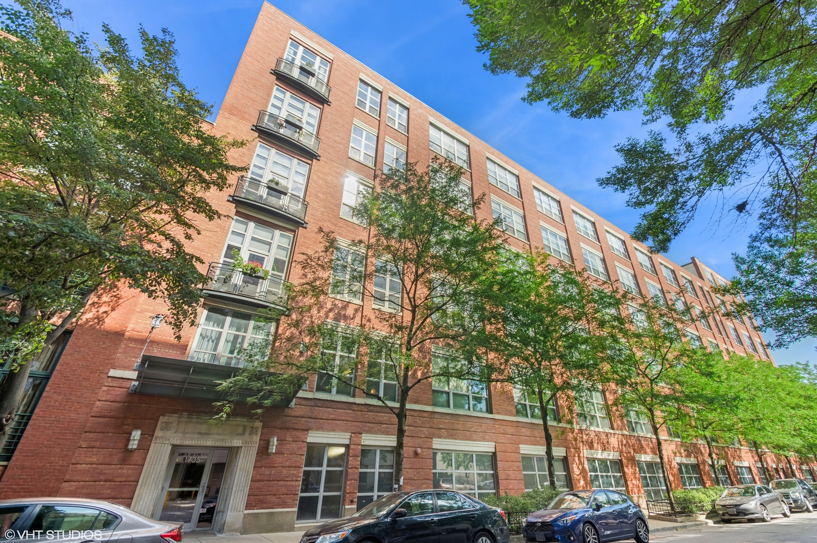 Check out this sunny end/corner unit, with high ceilings and exposed brick in Bucktown's highly sought over PAC Lofts. The condo features an open kitchen with stainless steel appliances, granite counters and a large moveable island. Spacious primary bedroom with a walk in closet, en-suite bathroom with double sink and separate shower and tub. Large second bedroom with ample closet space. Large windows in every room which illuminates the condo in natural light from the east and west. This elevator building has a spacious roof deck with skyline views, rec room, fitness room, court yard and lobby. Deeded parking space and storage included. Easy access to Walsh Park, the 606 Trail, CTA Blue Line, Metra, and countless restaurants, stores, and bars that Bucktown/Wicker Park have to offer. Virtual Tour Available.