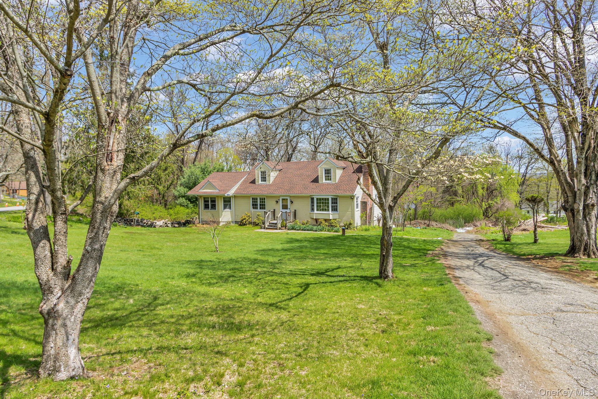Discover the perfect blend of country serenity and everyday convenience with this 4-bedroom, 3-bath Cape Cod, ideally situated on a quiet cul-de-sac in Somers. Set on a spacious 1.9-acre lot.  This home offers a peaceful, private setting with yard, garden & wooded privacyInside, the home showcases rustic charm with wood flooring, warm wood accents, and a classic white brick fireplace anchoring the inviting living and dining areas—perfect for cozy evenings. The bright, eat-in kitchen is filled with natural light and opens directly to a spacious rear deck, creating an easy flow for indoor-outdoor living and entertaining.A standout feature is the thoughtfully designed 1985 addition, offering a main-floor bedroom and full bath with a private entrance. This flexible space is ideal for a guest suite, home office, or multi-generational living arrangement.While the home is ready for your modern updates and personal vision, its solid structure, flexible layout, and unbeatable location, present a rare opportunity to build instant equity in a highly desirable Westchester community. Located in the Somers School district and tucked away on a dead-end street, this property combines tranquility with convenience.Bring your vision to transform this well-located gem into your dream home. Sold as-is and priced to move—don’t miss this unique opportunity!