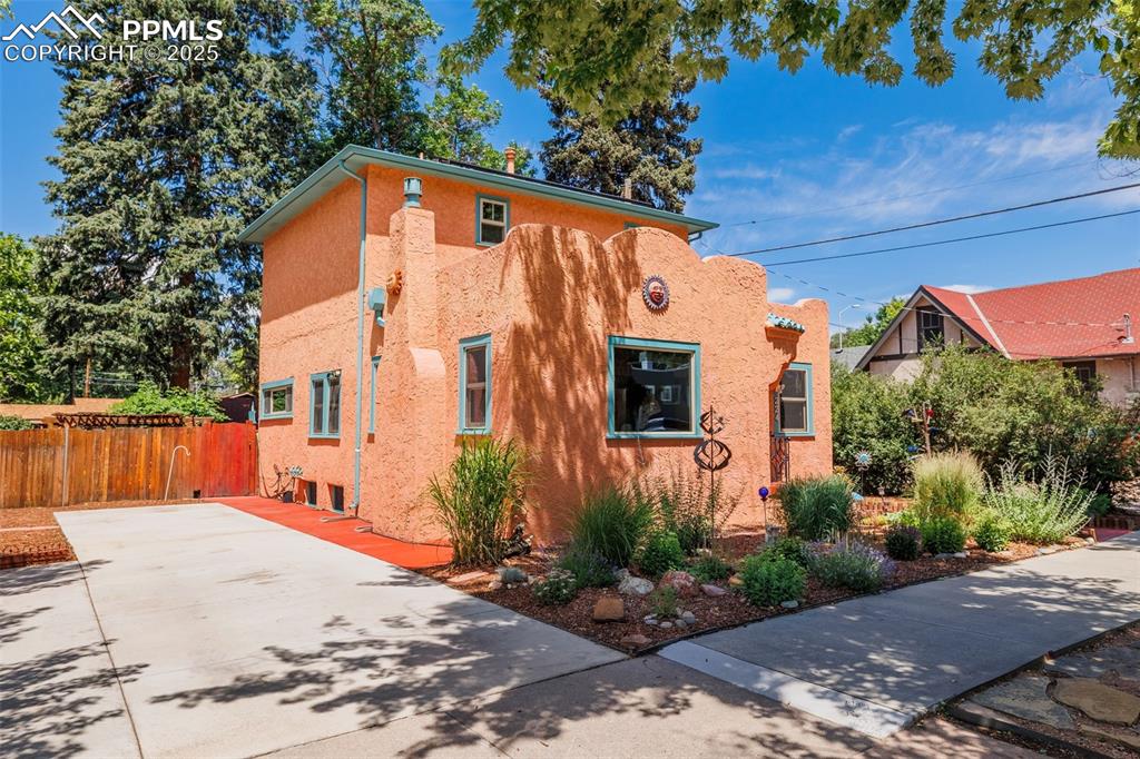 Amazing 1920 charmer! This incredible home has been lovingly updated and well maintained since 1994. A true Oasis nestled into a neighborhood close to downtown, parks, shopping and major arteries. The beautiful grounds include perennial gardens with blooms in all of the seasons. You enter this gorgeous property through the first garden on a flagstone walkway and enter the home through an arched custom wood door. The main level is graced with hardwood flooring, a gas fireplace, living room and dining area. Onto the remodeled kitchen with custom ceramic tile, newer dishwasher, gas range, refrigerator, two pantries and a butcher block. The partial basement has a laundry area and large storage space. Walk out to an expansive deck from the kitchen into a series of outdoor spaces and gardens including a circular stone patio and custom fence. Back into the home off the living room is a bedroom with laundry chute in closet, office and full bath with a large new slider accessing the large deck and yard area. Upstairs is the primary suite and another bedroom with a jack and Jill updated bath featuring a spa shower and marble vanity. The upstairs addition was completed in 2001 along with the electrical panel and plumbing updates. Solar panels were added in 2019, new furnace in 2024, newer hot water heater. The new windows on the main level( 2021), are triple paned with a warranty. Upstairs windows are double paned. The detached garage has alley access and can be used for vehicle storage or a workshop. the south side of the home has a large new driveway that can accommodate an RV. You are transported into a quiet, serene environment away from the business of the city when you come home to this Colorado retreat. This unique property is awaiting you!