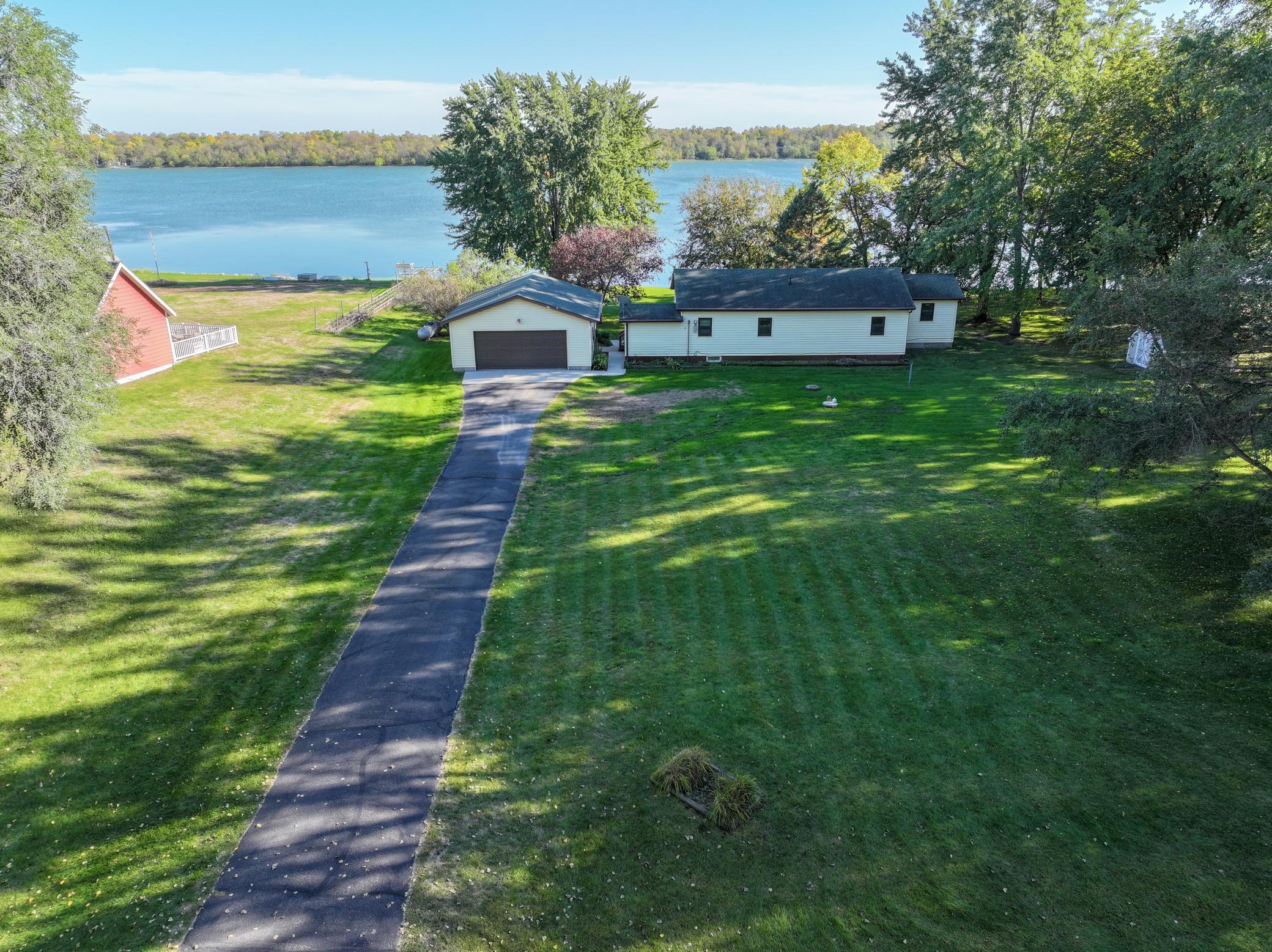 Welcome to lake living in this turnkey two-bedroom home on Pelican Lake. Ideally positioned on a level .86-acre lot with 148 ft of shoreline. As you enter the home from the wrap around deck, the kitchen provides the perfect gathering space while flowing effortlessly into the dining and living areas, making entertaining family and friends both easy and enjoyable. A cozy sitting area adds space to relax, unwind, and take in the peaceful surroundings. A spacious two-stall detached garage provides exceptional storage for vehicles, lake toys, and recreational gear. Maintenance-free siding, new septic system, new water heater, storage shed and more. Explore the opportunity to acquire this lakefront property today! Schedule a private showing...Life is better at the Lake!