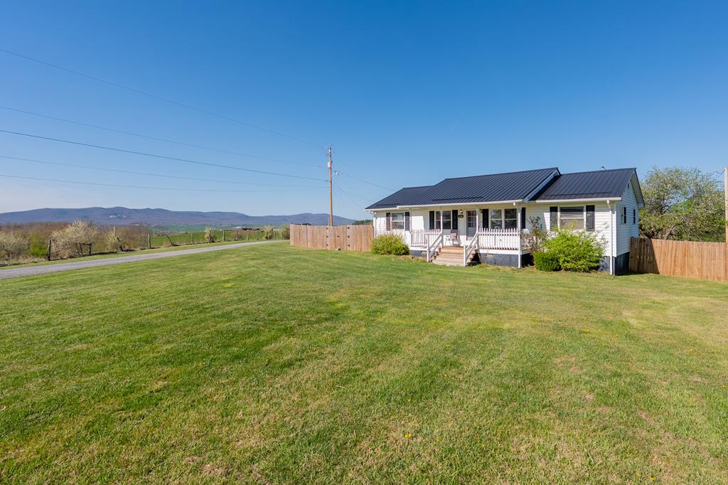 If you've been looking for space, flexibility, and true country living, this property delivers. Situated on 3.54 fully fenced and cross-fenced acres, this 3-bedroom, 2-bath home offers comfortable one-level living with approximately 1,482 sq ft of well-laid-out space. In addition to the main home, you'll find a detached guest house/in-law suite featuring roughly 418 sq ft, complete with its own full kitchen and bathroom—perfect for extended family, rental income, or a private workspace. The land is ready for whatever you have in mind. With farm fencing already in place, it's well-suited for horses, goats, cattle, chickens, or a full mini-farm setup. A large garden area provides plenty of room to grow your own food and enjoy a more self-sufficient lifestyle. Outbuildings are a major highlight here, including four total structures: two separate two-bay garages and two large storage buildings, giving you ample room for equipment, hobbies, and projects. The property is serviced by a private well and septic system, adding to the independence and functionality of the setting. Whether you're looking to homestead, expand your space, or simply enjoy the peace and privacy of country living, this one checks all the boxes. This 1/1 home will only be available for a short time. Call your agent today!