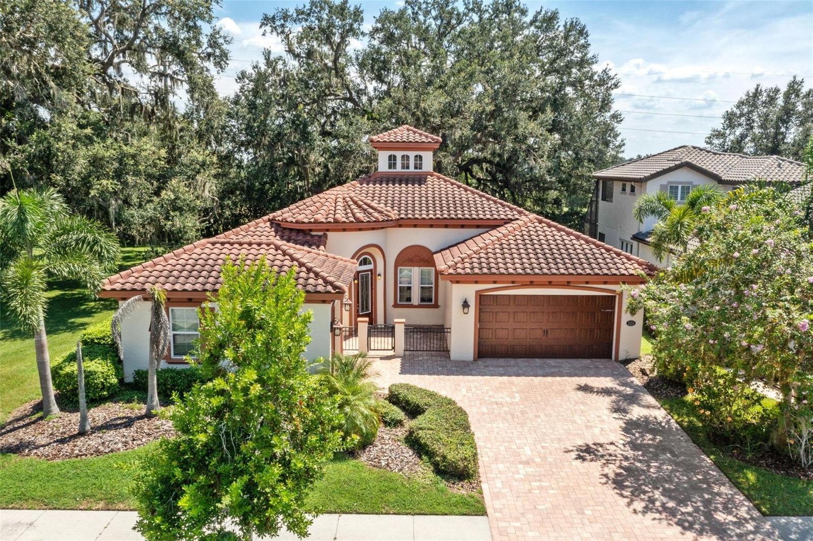 CUSTOM BUILT ONE STORY HOME! Located in the sought after GATED village of "The Gardens" on a quiet Culdesac lot & LOADED WITH UPGRADES! As you walk up you will notice the fully pavered driveway and large gated courtyard. 4 Bedrooms, 3 Full baths, and 3 Car Garage. Plus, there is a HUGE Covered Lanai with a canopy of big, beautiful shade trees!  Dream Kitchen with stainless appliances: Microwave, Dishwasher, Cooktop, built-in oven, garbage disposal, Refrigerator, Subway Tile Backsplash, Granite Countertops, large flat Center Island, abundant cabinetry, & Large walk-in custom Pantry. Kitchen with eat-in nook is open to Great Room w/ surround sound and soaring ceilings with double trays & heavy crown molding. Owners Retreat & Ensuite Spa Bath including dual sinks, Garden tub & walk-in shower w/dual shower heads, Huge Closet with built-ins. Upgraded Lighting & Tile. Relax in this beautiful home that has it all! Neighborhood features: Resort Style Zero Entry Pool & Splash Zone, 6 Ln Jr Olympic Pool, & pool by Pavilion. Fitness Center, Club House, Tennis & Basketball Courts, Large & Small Dog Park, Splash Court, 2 Large Parks with playground plus, Private Sports Courts with Playground & basketball Court in each village. Excellent location with a new Publix, Chick-fil-A, Florida Medical Clinic, a new Daycare, Starbucks, Circle K, nail shop, dental office, veterinarian, and much more coming just outside the entrance to the neighborhood. Close to Great Schools, Community College, Hospitals, Wire Grass Mall, Tampa Premium Outlet Mall, Ice Rink, Sams Club, Costco, Movie Theater, and lots of Dining. Easy access to I75, 275, Tampa Interational Airport and Downtown Tampa. CDD is already included in tax amount.