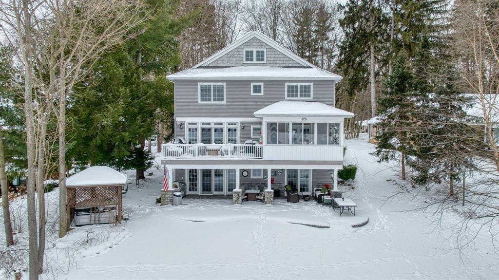 Browns lake charmer. This Nantucket style home is full of high end upgrades. Large kitchen which opens to the living room, provides great views of the lake.  Main floor bedroom with double closets and large bathroom with custom shower and tub. The upper level features 4 ample bedrooms with Jack and Jill baths.  On the upper most level is an amazing space for an art or hobby studio.  The lower walkout level has an amazing bar and rec room, wine cellar and high tech movie theater. There is a bonus ''vault'' room for those precious artifacts or just a cool lounge area. All this sits on a large lot featuring one of the premier lakes in Jackson, situated closest to the downtown or hospital. This All sports lake is waiting to fill your summers with relaxing boat rides or speed boat fun!