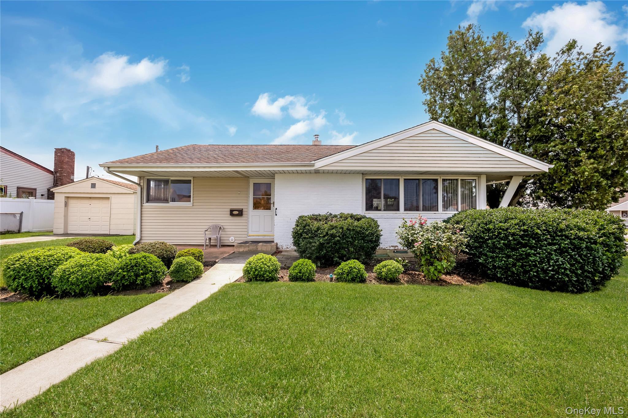 Nice Ranch situated on quiet block in heart of Bethpage, features good curb appeal w/brick & vinyl sided exterior, vinyl soffits, leaders & gutters, cement walkway, stoop, driveway & front cement Patio, fenced property, entry storm/screen door, wood door, Foyer w/ceramic tile floor, Living Room w/vaulted ceiling, built-ins, wall-to-wall carpeting & built-in air conditioner, Dining Room w/refinished hardwood floors & ceiling fan, Eat-in Kitchen w/laminate flooring & ceiling fan, ceramic tile Full Bath, 2 Bedrooms w/refinished hardwood floors, double closet & built-in air conditioner, full unfinished Basement w/OSE, Basement new drainage, Laundry Room w/washer & dryer, oil heat, heating system 5 years old, above ground 275 gallon oil tank only 11 years old, newer chimney liner 12 years old, new 150 amp electric, all windows replaced, verticals, 1.5 car detached garage w/electric garage door opener, garage roof 15 years old, privately fenced backyard, 6ft PVC fencing, patio, underground sprinklers, convenient to all transportation & shopping, Plainedge School District #18.