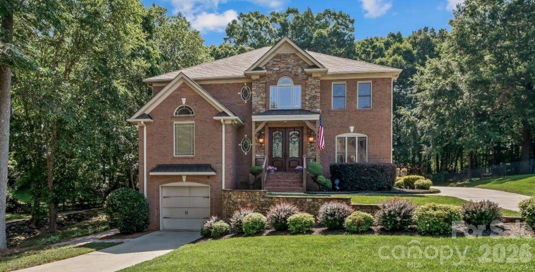 WEDDINGTON SCHOOLS Exceptional custom home with resort-style outdoor living and extensive upgrades throughout. Built by a custom builder as a personal residence, this 5BR home offers approximately 4,433 finished square feet PLUS an additional ~744 heated and air-conditioned square feet in the basement - drywall and flooring away from finished, and counted in neither the finished total nor the bedroom count, which brings it to 5,177 total heated and cooled square feet under roof! Together it all blends luxury, craftsmanship, and function on over half an acre backing to Wesley Chapel Elementary.The backyard is built for gathering: two fire pit areas, horseshoe pits, and extensive string lighting, all enclosed by split-rail fence beneath mature oaks. Terraced hardscape garden beds hold established fruit-bearing blueberry bushes, with blackberry vines along the fence line. An 8-zone irrigation system with drip lines serves upper and lower beds. A 234 SF three-season room on the main level overlooks the patio and backyard (not heated/cooled), with screened storage below for lawn equipment.Dual 8-ft front doors open to a 6-ft-wide entry and a dramatic two-story foyer with chandelier and lighted display niches. The living room centers on a gas-log fireplace with floor-to-ceiling stone, custom built-ins, bi-fold TV concealment doors, detailed tray ceiling, and hickory hardwoods. Built-in surround sound extends through the living room, kitchen, and three-season room, and the home is hardwired with CAT5 networking.The gourmet kitchen features a professional Viking gas cooktop with pop-up ventilation and pot filler, built-in KitchenAid microwave/oven combo and warming drawer, built-in refrigerator, touch faucet, new LED cabinet lighting, illuminated glass-front displays, custom slide-out Purpleheart/walnut/oak cutting board, built-in desk, and a bay-window breakfast area. The adjacent dining room offers a built-in serving bar with upper and lower cabinetry, accent lighting, and sconces.The main-level primary suite is a true retreat: tray ceiling, private sitting room with a second gas-log fireplace, and hickory floors. The bath includes his-and-her walk-in closets with cedar floors, dual vanities, sunken Jacuzzi tub, and a dedicated shower room with dual heads and body jets.A mudroom off the garage offers built-in bench, cubbies, wainscoting, and chalkboard wall; the laundry room features a custom white oak cabinet system behind sliding barn doors.Upstairs, a large loft with built-ins and dual desk workstations anchors a secondary primary suite with private bath and walk-in closet, two bedrooms joined by a Jack-and-Jill bath, a flex room currently used as a bedroom, and two large walk-in attic spaces.The finished basement adds incredible flexibility: a home theater with two-tier seating, six powered recliners with USB ports and under-seat lighting, 85-inch TV, Klipsch surround sound, popcorn bar, and refrigerator; a fitness room with 3/4-inch mat flooring; a large workshop with natural light and egress potential for a future bedroom; and a utility/galley area with sink and washer/dryer hookups ready for a future kitchenette. The workshop and utility room are heated and cooled (the ~744 SF noted above) and need only drywall and flooring to become finished living space. Custom red oak bi-fold doors conceal generous closets in both the theater and fitness rooms, and finished areas feature waterproof flooring. Tremendous multigenerational potential.Additional highlights: upper 2-car garage plus lower 1-car garage with separate driveway, whole-home central vacuum with long-hose attachment for car detailing, fridge water line plumbed for a second ice maker, Wi-Fi thermostats, and Alexa-compatible smart lighting in select areas. This one was thoughtfully planned down to the smallest detail. WEDDINGTON SCHOOLS (currently assigned - buyer to verify)