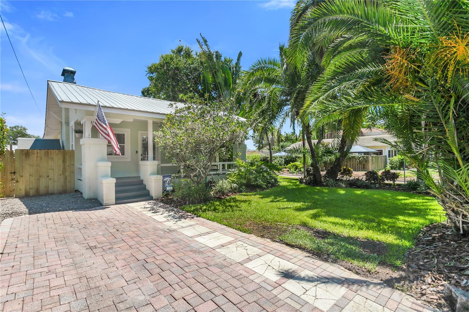 This home is truly a must-see! Featuring 3 bedrooms, 2 bathrooms, and 1,250 sq ft of living space - when you include the bonus mother-in-law suite in the rear with its own private driveway. Situated on a corner lot, in Flood Zone X, with lush tropical landscaping, two separate driveways, and ample outdoor living
space, your search ends here! As you step onto the charming front porch, fully shaded and
perfect for relaxing mornings or evening gatherings, you'll immediately feel at home. Inside,
you're welcomed by a classic bungalow layout featuring original hardwood floors, abundant
natural light, and tasteful updates that blend seamlessly with the home's historic character. The
renovated kitchen includes granite countertops, stainless steel appliances, and custom
cabinetry, perfect for both casual meals and entertaining. The two bedrooms offer cozy, private
retreats with ample closet space, and the fully renovated bathroom features modern fixtures
while maintaining a vintage charm. Out back, the detached guest suite, complete with its own
bathroom, is an ideal space for visitors, a private office, or even a potential rental income
source. The fenced-in backyard and covered side porch offer privacy and multiple options for
outdoor enjoyment. Some notable updates include HVAC in 2023, a Metal Roof, a New Fence
in 2025, and a Fully renovated bathroom in 2023. Located in the highly sought-after Palma
Ceia neighborhood, this home is just steps away from Roosevelt Elementary, Bayshore
Boulevard, and some of South Tampa's best retail and restaurants. Don't miss your opportunity
to own this rare gem that perfectly combines classic charm with flexible modern living!