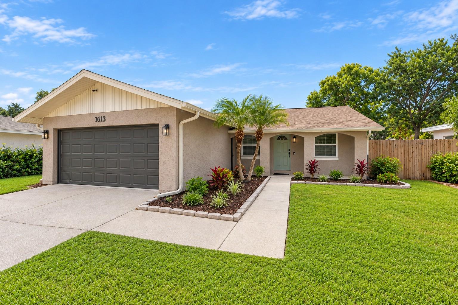 STUNNING Designer finishes in this spacious 4 bedroom, 2 bath, 2 car garage POOL home with private PUTTING GREEN in your large fenced yard in one of Dunedin’s most sought-after neighborhoods, Piper's Glen. NO Flood Zone! Located in Dunedin's A-Rated school zone! Newer windows. This home has all the functional space and luxury finishes one could desire. As you arrive at this home, you will notice the charming curb appeal with modern exterior paint and hexagon mosaic patterned tile under your welcoming front porch. Inside the home boasts new waterproof luxury vinyl plank flooring, stylish Shiplap wainscotting throughout the oversized living area, fresh paint and modern fixtures, including gold wall sconces. Tastefully updated kitchen with 42" custom two-toned slim shaker cabinets, dazzling Quartz counter tops, new stainless steel appliances, Gold hardware and tri-color subway tile backsplash. Additional storage provided with a desired cabinet pantry complete with beverage station featuring refrigerator and floating shelves for display. Dinette area showcases Walnut acoustic paneling and trendy pendant light. French doors provide plenty of natural light throughout. Primary suite is spacious with plantation shutters and wood slat panel barn door access to your Spa-like en suite bathroom featuring hexagon tile flooring, fluted and matte gleaming tile finishes, Gold touches including rainfall shower head and seamless glass entry panel. Three additional guest bedrooms are spacious and provide plenty of closet space. Fourth bedroom is perfect for an office/flex space. Hall bathroom boasts Marble vanity and contemporary tile shower/tub combo. Frosted glass doors lead to interior laundry for added convenience. French doors from the kitchen lead to your backyard tropical oasis featuring your own personal putting green, Pool, patio for entertaining and oversized fenced yard for plenty of private green space. Two-car garage provides all the additional storage you need. Newer water heater 2024. Piper's Glen offers a community pool and easy access to Amberlea Park and playground. Minutes to top A-rated Dunedin schools while you enjoy the desired Dunedin lifestyle with golf cart access to Downtown Dunedin to visit the local restaurants, shops, social activities, waterfront parks, and access to the Pinellas Trail. Close to award-winning pristine beaches and spectacular sunsets of Honeymoon Island. Conveniently located to a variety of restaurants, Westfield Countryside mall, easy access to US-19 and more! Don’t miss your chance to own this beautiful home in Piper’s Glen!