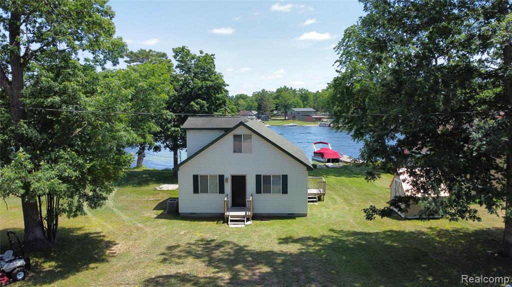 Check out this dreamy lakeside escape! With 63 feet of frontage on Sand Lake in the heart of Harrison, you're right in the middle of Michigan’s beloved Chain of Lakes—a perfect spot for boating, fishing, or just soaking up the peaceful views. The Cape Cod charm paired with fresh updates and that breezy beach decor makes it feel like a vacation home you never have to leave.  On the main floor you will find a primary bedroom and full bath, plus two more bedrooms and a second full bath upstairs, so there's plenty of room for guests or that growing family!  Most of the flooring has been updated, all appliances are staying and furnishings are negotiable.  Great location and close to trails, golf, and year-round outdoor fun.