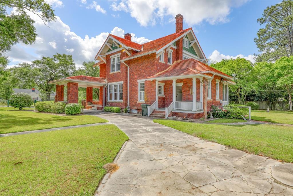 A Rare Historic Masterpiece in the Heart of Moultrie Welcome to 902 2nd Street SE, an exceptional offering in Moultrie's rich architectural landscape. Thought to be the work of renowned architect Solomon Andrew Layton—the visionary behind the Oklahoma State Capitol—this 1912 brick residence is a striking example of early 20th-century design and craftsmanship. Spanning over 4,100 square feet on a generous 0.62-acre lot, this 3-bedroom, 2.5-bath home blends grandeur with livability. Period details abound: hardwood floors, vintage tilework, detailed millwork, ornate fireplaces, and classic light fixtures—each a testament to the enduring quality and refined elegance of its era.  The home's exterior is equally distinguished, featuring solid red brick construction, a terracotta tile roof, porte-cochere, and a detached garage built for Moultrie's very first automobile. This garage would also make a beautiful guest home. Mature landscaping surrounds the property, offering privacy and a sense of timeless serenity. The expansive unfinished attic provides opportunity for additional living space, creative use, or extensive storage. Located just a short stroll from Moultrie's charming downtown, this property offers the rare chance to own a legacy. Homes of this caliber—and historical provenance—rarely come to market. Whether you're an architecture enthusiast, a preservation-minded homeowner, or a buyer seeking something extraordinary, 902 2nd Street SE is a once-in-a-generation opportunity to steward one of South Georgia's architectural treasures.  The owner is a licensed agent in another state.