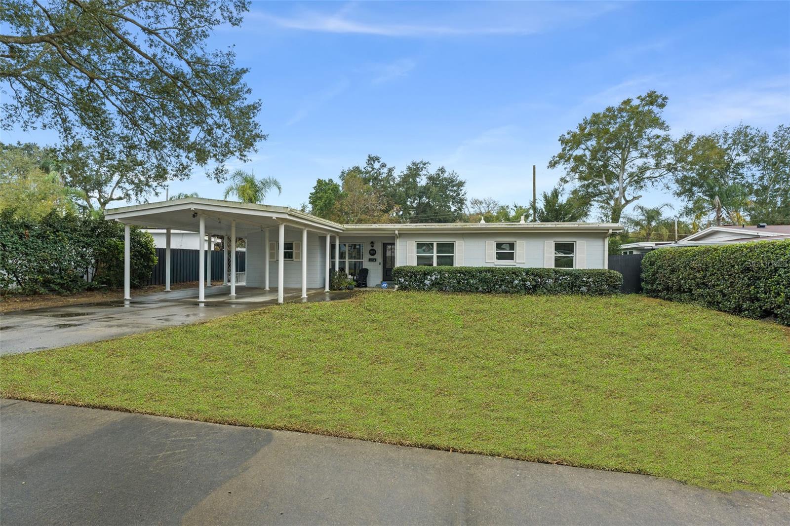Under contract-accepting backup offers. Step into this beautifully and professionally updated 1,717 sq ft, 4-bedroom, 2-bath home in Dover Shores where modern design meets everyday comfort. The heart of the home is a bright, open-concept kitchen featuring striking Navy blue cabinetry, brass hardware, and sleek white quartz countertops that extend to a generous center island—perfect for casual dining or entertaining. Warm wood floors ground the space, while designer brass pendant lighting and a crisp white subway tile backsplash add a high-end, curated feel. Large windows flood the home with natural light, seamlessly connecting the kitchen to the living area and creating an inviting, airy flow throughout. An adjacent family room is perfectly situated for gathering and relaxing. A fenced backyard with gazebo and hot tub offer a private escape. Located just minutes from downtown Orlando, and convenient to major highways, restaurants and retail. Zoned for the Como K-8 and Boone High School. Roof was installed in 2020. New HVAC in 2022 and 2020.