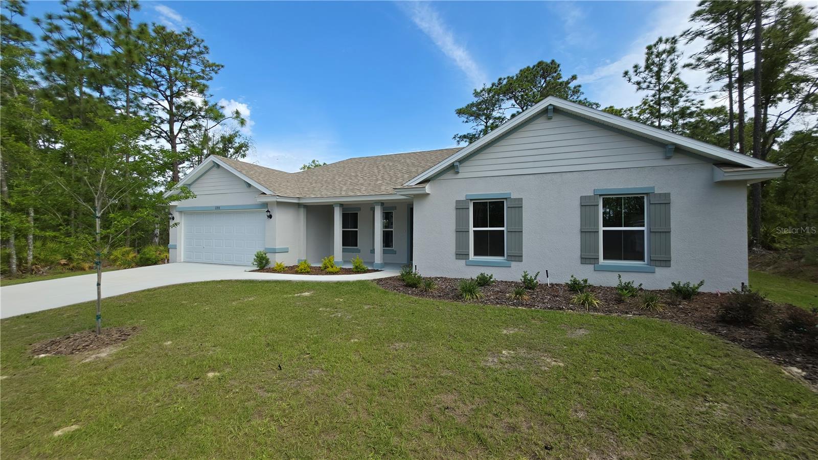 WOW! Welcome to 1353 W Cary Drive, a beautifully built new construction Myrtle model tucked away on a quiet street in the heart of Citrus Springs. This thoughtfully designed 3-bedroom, 2-bath, 2-car garage home offers upgraded finishes throughout, combining quality craftsmanship, everyday functionality, and the peace of mind of a 10-year structural builder warranty.Step inside to an open and inviting layout featuring luxury vinyl plank flooring throughout the main living areas, kitchen, bathrooms, and laundry room, while the bedrooms offer plush high-end carpet for added comfort. The kitchen is both stylish and functional with granite countertops, a large center island, soft-close solid wood cabinetry, stainless steel GE appliances including range, microwave, dishwasher, garbage disposal, and plenty of workspace for cooking and entertaining.The roomy primary suite offers a cozy private retreat, complete with a double vanity bathroom featuring granite countertops and a beautifully finished floor-to-ceiling ceramic tile walk-in shower that creates a true high-end feel. The two guest bedrooms provide plenty of space and comfort for family, visitors, or a home office setup, while the guest bathroom carries the same quality finishes with granite countertops and a matching floor-to-ceiling tiled shower, giving the entire home a polished and consistent design throughout.Sliding glass doors lead to an extended rear patio and a spacious backyard with plenty of room for outdoor dining, entertaining, pets, gardening, or simply enjoying the quiet surroundings. The covered front porch adds even more charm and creates a welcoming first impression from the moment you arrive.Additional features include a garage door opener, attic stair pull-down, two ceiling fans, and a full irrigation system to help keep the lawn looking its best year-round.Located in beautiful Citrus Springs, you’ll enjoy nearby walking and biking trails, the natural beauty of Rainbow Springs just 15 minutes away for swimming and kayaking, and everyday conveniences like Target, Walmart, restaurants, and shopping only 10 minutes from home. This is Florida living with the perfect balance of comfort, convenience, and quality new construction.
