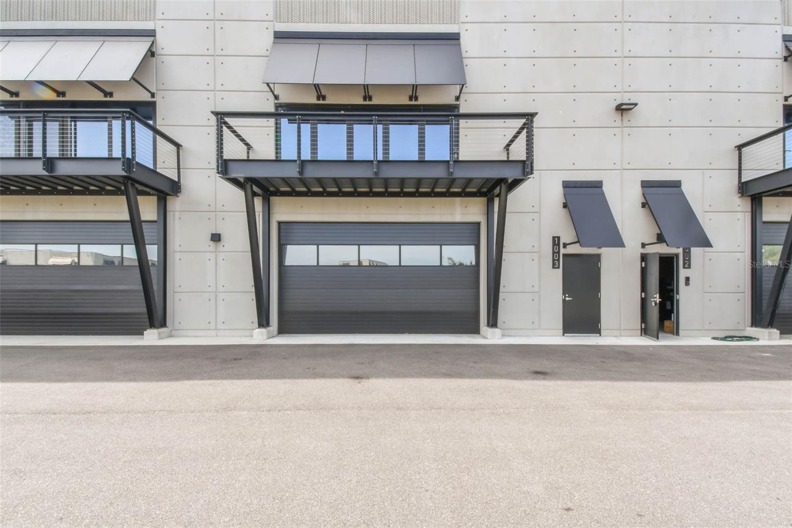 Immerse yourself in the ultimate motorsports lifestyle at the Motor Enclave, the largest private garage community in the world. This 1,435-square-foot private garage offers soaring 25-foot ceilings and a private balcony with direct views of the adrenaline-charged racetrack. With room to accommodate over seven cars and the potential to add a mezzanine to nearly double the square footage, this space is a blank canvas awaiting your vision. Whether you're showcasing your collection, entertaining clients, or indulging in high-performance experiences, Garage #1003 is the ultimate car collector's dream garage. Designed for functionality and future buildout, it comes pre-plumbed for water and sewer, allowing for the addition of a private bath or kitchen, an individual HVAC unit on the roof, a fire sprinkler system, and an insulated overhead door, ensuring that every detail meets the highest standards. Ownership here is about more than just the garage—it’s about the experience. Located on 200 private, gated acres, this motorsports community offers unmatched convenience, experience and prestige, all just minutes from Tampa International Airport, downtown Tampa, Tampa Executive Airport, and just over an hour from Orlando. Membership at the Motor Enclave includes access to a 1.72-mile Performance Circuit designed by Hermann Tilke, the globally acclaimed architect behind many of today’s premier Formula 1 tracks, a 100-acre off-road course and two-acre skid pad for dynamic vehicle testing and adrenaline-fueled fun, and a 37,000-square-foot clubhouse offering a variety of social, corporate, and leisure amenities. The resort-style pool and lounge area is perfect for entertaining guests while you take to the track. More than just a garage, this is your gateway to an automotive lifestyle, with optional membership to the Enclave Motorsports Club providing weekly track access, exclusive VIP events, and a community of like-minded enthusiasts. Schedule your private tour today and experience firsthand why the Motor Enclave is the premier private garage community.