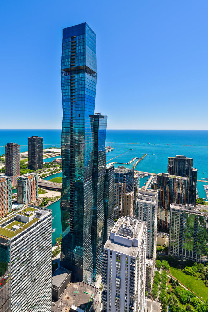 Discover the epitome of luxury living at The St. Regis Residences, an architectural masterpiece designed by award-winning Jeanne Gang of Studio Gang. Inspired by the facets of a shimmering gem, this iconic tower graces the coveted Lakeshore East neighborhood, offering an unparalleled lifestyle. Step into this exquisitely designed high-floor northeast corner residence- a spacious 3-bedroom + den, 2.5-bathroom home with a private balcony that redefines city living. Floor-to-ceiling windows flood the open-concept living and dining area with natural light, showcasing breathtaking views of the city skyline, Chicago River, and Lake Michigan. The versatile den serves as a perfect home office or additional lounge space.  At the heart of this residence is a chef's dream kitchen, featuring Gaggenau appliances, sleek Snaidero cabinetry, and stunning countertops. Wide-plank hardwood flooring enhances the sense of warmth and sophistication throughout. The spa-like bathrooms boast full-height stone walls and Robern medicine cabinets, offering a serene retreat.  Beyond your private sanctuary, The St. Regis Chicago presents an unrivaled collection of world-class amenities, including:Outdoor pool and hot tub with stunning city and water views, Sky lounge with panoramic lake, river, and skyline vistas, State-of-the-art golf simulator, Private cinema, Fully-equipped fitness center with steam and sauna rooms, Indoor-outdoor kitchen, wine vault, and private dining room, Dog lounge with an indoor run, and Direct access to the 5-star hotel and its opulent amenities, including a 5,600 sq. ft. fitness center, yoga studios, a luxurious spa, an indoor pool, and exceptional dining options  Nestled at the intersection of the Chicago River and Lake Michigan, this residence offers a premier location just moments from the city's finest parks, cultural landmarks, shopping, and dining destinations.  Elevate your lifestyle at The St. Regis-where luxury meets breathtaking design and world-class convenience.