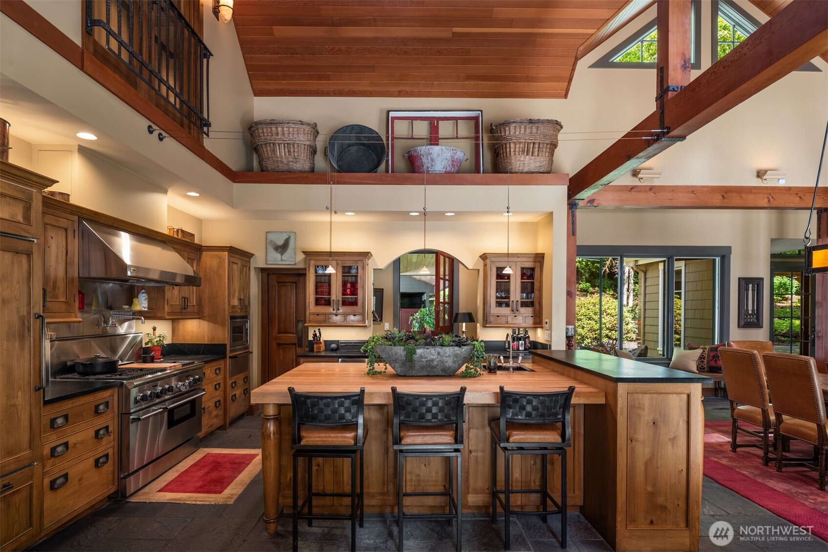 Butcher block island, bar seating, and loft storage