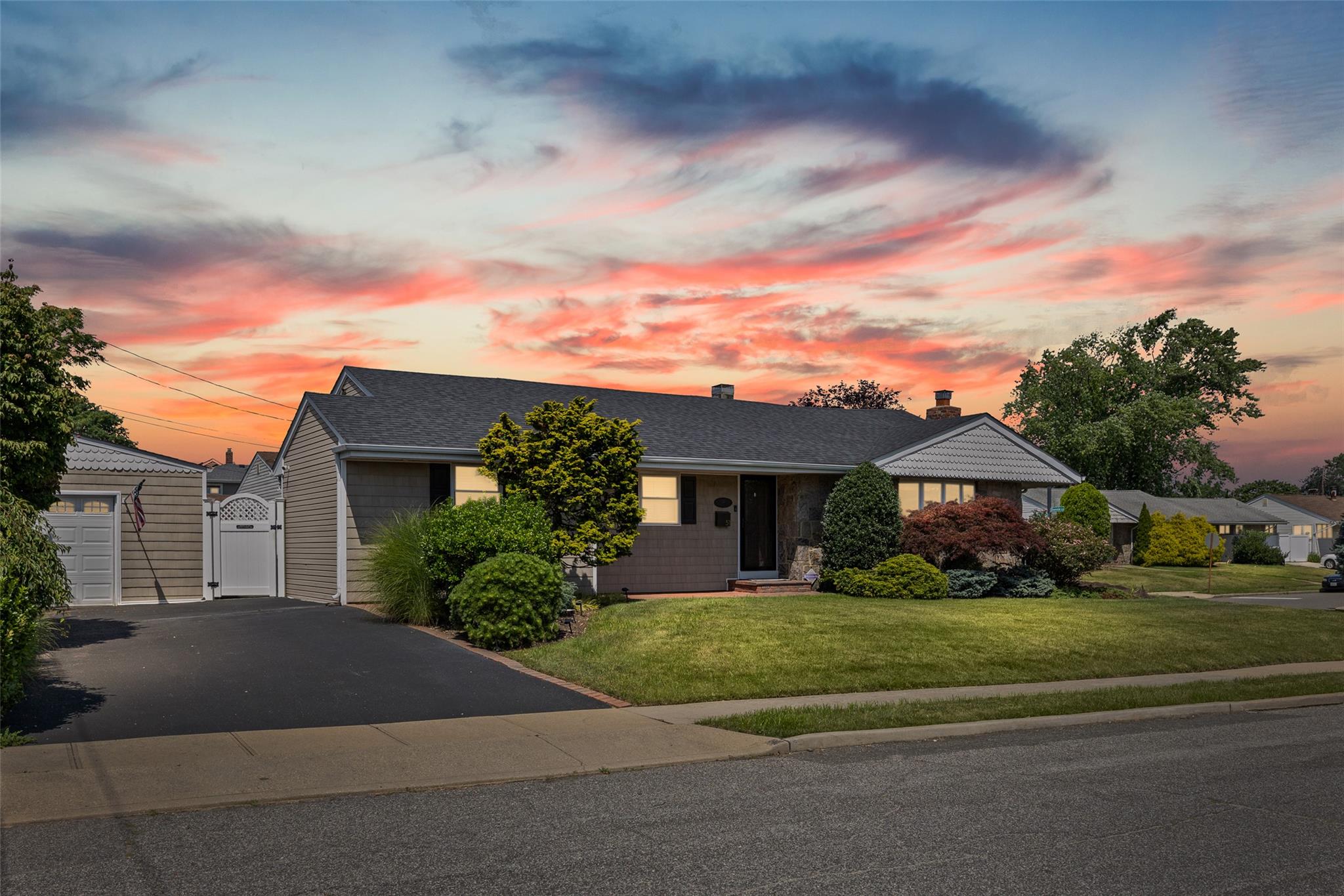 Meticulously maintained ranch-style home featuring 4 bedrooms and 3 full baths. The open layout includes a gourmet eat-in kitchen with wood cabinetry and granite countertops, flowing into a bright living room with a decorative stone fireplace.

The primary bedroom offers a private en-suite bath. Three additional sunlit bedrooms share a full hallway bath with tub. Gleaming hardwood floors throughout.

The partially finished basement is spotless and includes a full bathroom—ideal for extra living space or guests. Enjoy a private, fenced backyard with a stone patio, perfect for outdoor entertaining.