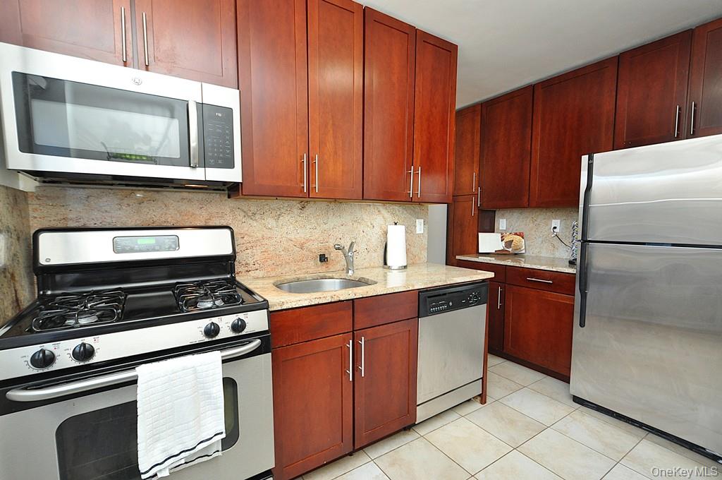 Welcome home to this top floor, bright and inviting two-bedroom, dog-friendly co-op with the added convenience of your own DEEDED PARKING SPACE. This move-in-ready home features a beautifully renovated eat-in kitchen with granite countertops, stainless steel appliances, and rich rosewood cabinetry—perfect for everyday cooking or casual dining.  The updated bathroom offers clean, modern finishes, while the spacious living room provides flexibility for both relaxing and entertaining, all set against gleaming covered hardwood floors throughout.  The primary bedroom is generously sized to accommodate a king-size bed and additional furniture and includes a full wall of closets. The second bedroom, a sunny corner room, is ideal for guests, a home office, or nursery.  Enjoy the ease of parking in your own assigned deeded space, laundry conveniently located on the first floor, and a location that truly delivers—just a five-minute walk to the Hartsdale train station and nearby shopping, with a 30-minute commute to Grand Central Terminal.  Maintenance does not reflect STAR credit. Two cats are permitted or one dog under 25-lb weight restriction. Parking space #304