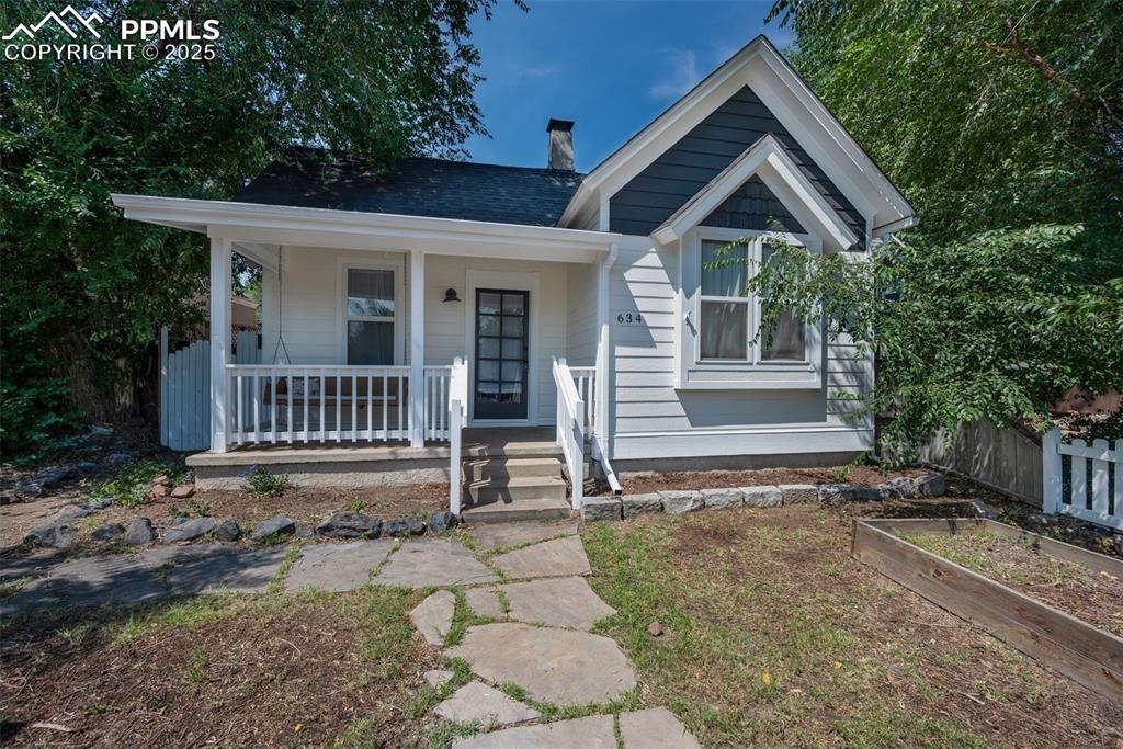 Charming and fully move-in ready, this beautifully updated 1925 ranch sits in one of Colorado Springs’ most coveted neighborhoods—just two blocks from Colorado College and moments from the historic Old North End. You'll love the NEW and BEAUTIFUL, designer-selected historic exterior paint! Set on a premium 6,000 sq ft lot with rare R2 zoning, the property offers standout potential for a second home or rental unit, with convenient side and rear alley access making future development a breeze. Step through the classic white picket fence to a welcoming front porch framed by garden boxes ready for seasonal blooms. Inside, two generous bedrooms feature walk-in closets, and a stylishly remodeled bathroom blends vintage charm with modern finishes. The cozy living room invites you in with its charming stove, while the updated kitchen shines with white Shaker cabinetry, subway tile, and a gas range. A spacious laundry area provides room for a dining nook, adding flexibility to the layout. Outdoor living is effortless with dual backyard doors—one opening to a private deck ideal for al fresco meals, the other leading to a serene patio and fenced yard. Blending modern upgrades, timeless character, and exceptional expansion potential, this home offers a rare opportunity in an unbeatable central location. See Agent/Showing Remarks. 3 virtually staged photos.