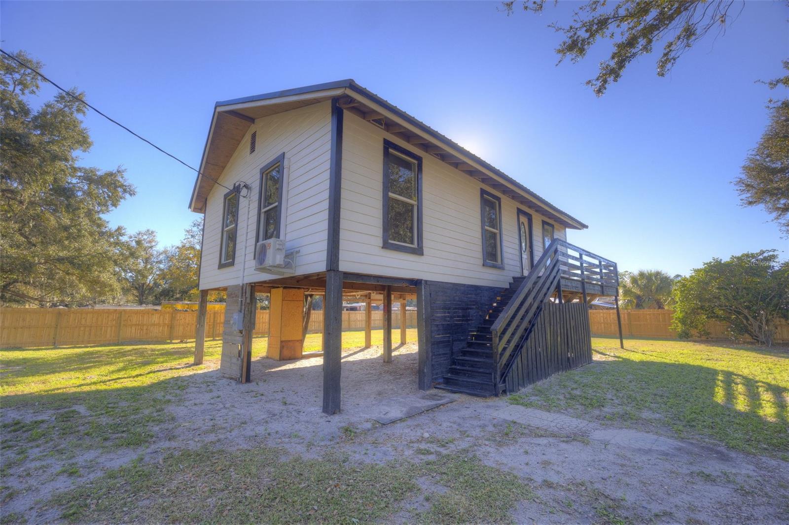 Welcome to this beautifully renovated home, thoughtfully redesigned for modern living and perfectly positioned on just over ? of an acre with picturesque views of a strawberry field across the street. Elevated on stilts, the home offers both charm and peace of mind, along with a sense of privacy and open space rarely found at this price point.Inside, you’ll find a smart and functional floor plan with two bedrooms and a well-balanced layout. The spacious primary bedroom is tucked away for added privacy, while the secondary bedroom sits on the opposite side of the home—ideal for guests, roommates, or a home office setup. A centrally located bathroom and hallway connect the living spaces seamlessly.The open living room flows into the dining area and kitchen, creating a comfortable space for everyday living and entertaining. Natural light fills the home, enhancing the fresh updates completed by the seller throughout—making this property truly move-in ready.Outside, the expansive lot offers endless possibilities for outdoor living, gardening, storage, or future improvements, all while enjoying serene views and a peaceful setting.If you’re looking for a fully renovated home with land, character, and a unique setting, this one is a must-see.