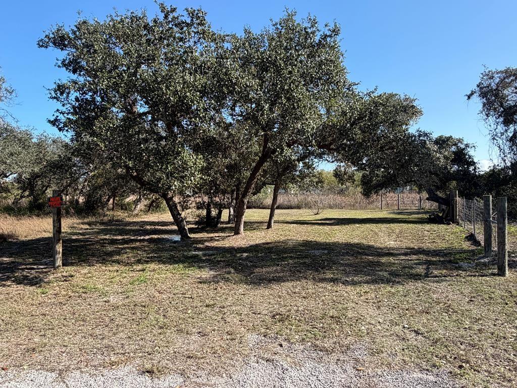 Large 0.21 acre lot located in the Oak Shore section of Holiday Beach. This quiet cul-de-sac location offers added privacy with established trees and a wider pie-shaped layout than standard interior lots. Holiday Beach provides access to a community pool, lighted fishing pier, boat ramps, and a low annual HOA. Community water is available and a septic system is required. A great setting for a future coastal home in a well-kept residential area with consistent development.