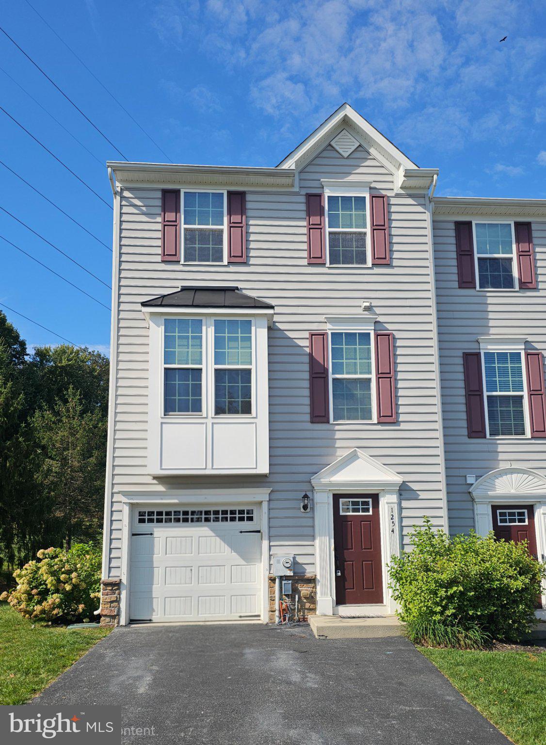 Welcome to Meadowview! Discover this spacious 3-story, 12-year-young end-unit townhome tucked away in a serene countryside setting while still offering a convenient location. This home provides an abundance of living space, privacy, and flexible options for today's lifestyle. The lower-level entry welcomes you into a charming greeting area with access to the one-car garage and a huge versatile family room. Use this space as a family room, home office, exercise area, hobby room, or even a private retreat for a teenager or college student. Sliding doors lead directly to the beautiful rear and side yard areas.Hardwood tread stairs lead to the expansive second level featuring a wonderful open-concept floor plan. The spacious eat-in kitchen flows seamlessly into the living room, creating an ideal space for everyday living and entertaining. The kitchen features a 5' x 4' granite island, 42-inch cabinetry, double pantry closet, built-in microwave, stainless-steel refrigerator with water and ice dispenser, and matching propane gas range. The generous dining area easily accommodates a large table and offers views of the rear deck and garden area. Beautiful hardwood flooring extends throughout this entire level, including the living room and convenient powder room.  Continue upstairs to the third-level bedroom area. There are two nicely sized hall bedrooms, a full hall bath with tub/shower combination, and a convenient hallway laundry area with Samsung washer and dryer. The spacious primary bedroom measures approximately 16' x 14' and features a beautiful tray ceiling and walk-in closet. The primary ensuite bath offers a luxurious double-sized shower with two rain shower heads, along with a double-sink vanity.  One of the highlights of this end-unit home is the 22' x 14' composite deck, conveniently located just off the kitchen. A privacy wall separates the deck from the neighboring home, creating a wonderful outdoor retreat. Enjoy peaceful views, nature, and outdoor living from this special end-unit location. The Meadowview Association fee is only $137 per month and includes common area maintenance and insurance, lawn maintenance, and snow removal.  Priced to sell and being offered as-is, this home presents an opportunity to add your personal touches and build equity. Bonus, only 10 minutes to the Thorndale commuter station, traveling east or west, as well as shopping and restaurant district nearby. This home will benefit from TLC, including cleaning and/or carpet replacement on the third level, along with your choice of paint and cosmetic updates. Bring your imagination, vision, paint brush and make this spacious end-unit townhome your own!  Important property information: The home has been winterized and the water is currently turned off. Electric and heat are on. Water will be reconnected soon. Buyer is responsible for performing their own due diligence and inspections. Contact the listing agent with any questions. This community has recent sales from the low $400,000 to $450,000 range - your chance is now to buy this property and give it your loving touches.