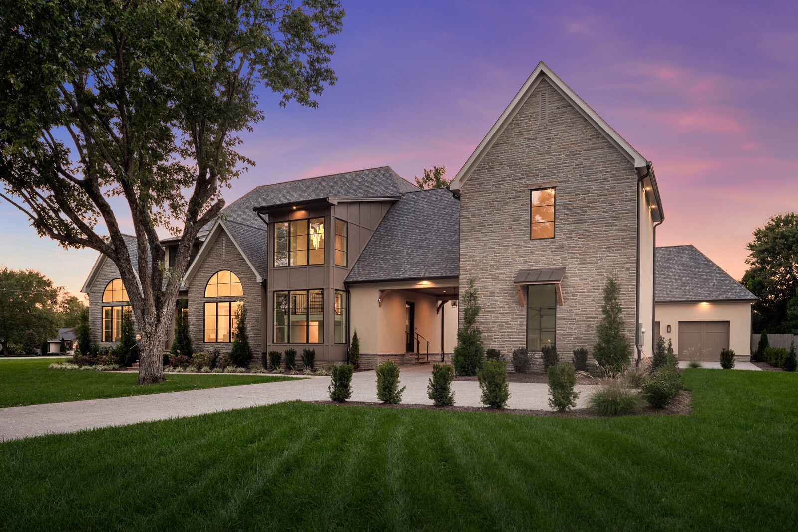 Set on nearly an acre in one of Brentwood’s most desirable neighborhoods, this 6,000+ SF transitional-style home pairs timeless design with modern luxury. With 5 bedrooms, 5 full and 2 half baths, it’s thoughtfully designed for both everyday living and elegant entertaining. The light-filled interior features 10’ ceilings, 4" white oak hardwoods, and a chef’s kitchen with Wolf and Sub-Zero appliances. The great room and hearth room open to a covered patio with built-in outdoor kitchen—perfect for summer gatherings or cozy fall evenings. The main-level primary suite offers a private porch and spa-like bath. A 4-car garage, EV charging, and central vac add convenience, while zoning for top Williamson County schools completes the package.