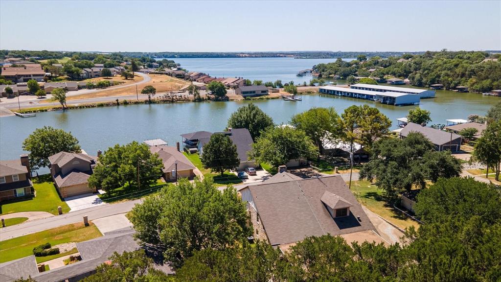 Just one block off the lake, this home has been recently renovated and is ready for it's new owners in the guard gated golf community of DeCordova Bend Estates. An incomparable value, the amenities of country club living include golf, pool, tennis, pickle ball, restaurant, marina and much more. Home sits all within a block or two of all the fun yet is tucked away on a quiet cul de sac. Meticulously updated with marble tile flooring, newer appliances, stone countertops and bath updates. Light and bright, you'll love the ample space, tons of storage space, and flex space. A quaint nook upstairs can easily double as dedicated office space, playroom or even a fourth bedroom. Likewise the sizable second living space downstairs could easily be converted into a primary bedroom. Out back is a private yard with large covered carport for your boat and vehicles and a small garage space for a golf cart or extra storage. This home puts you right in the heart of the community, minutes from historic downtown and is located on the Fort Worth side of 377 for quick and easy access to all points north.**Listing goes live early February.